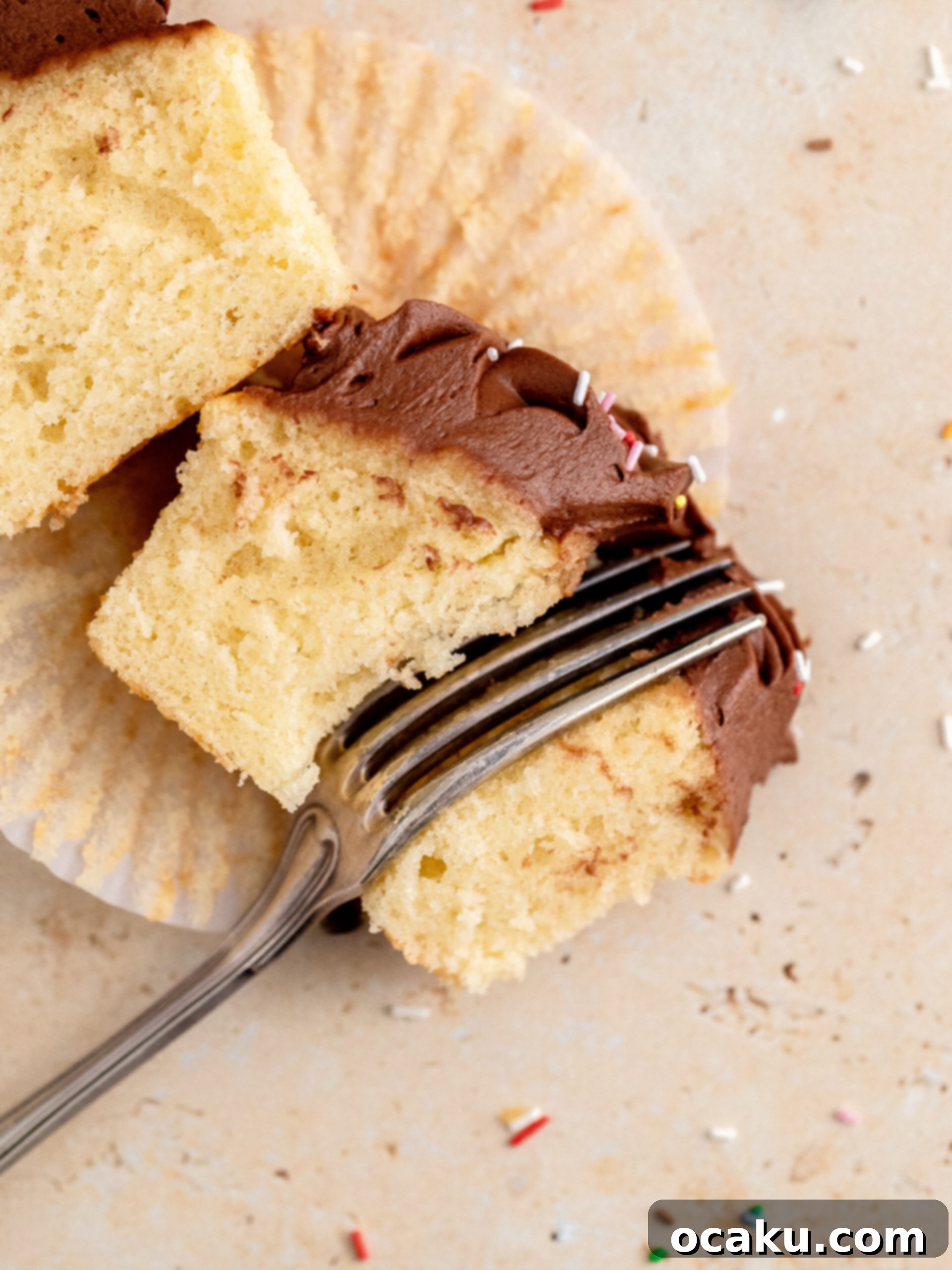 A row of beautifully decorated chocolate and vanilla cupcakes with sprinkles.