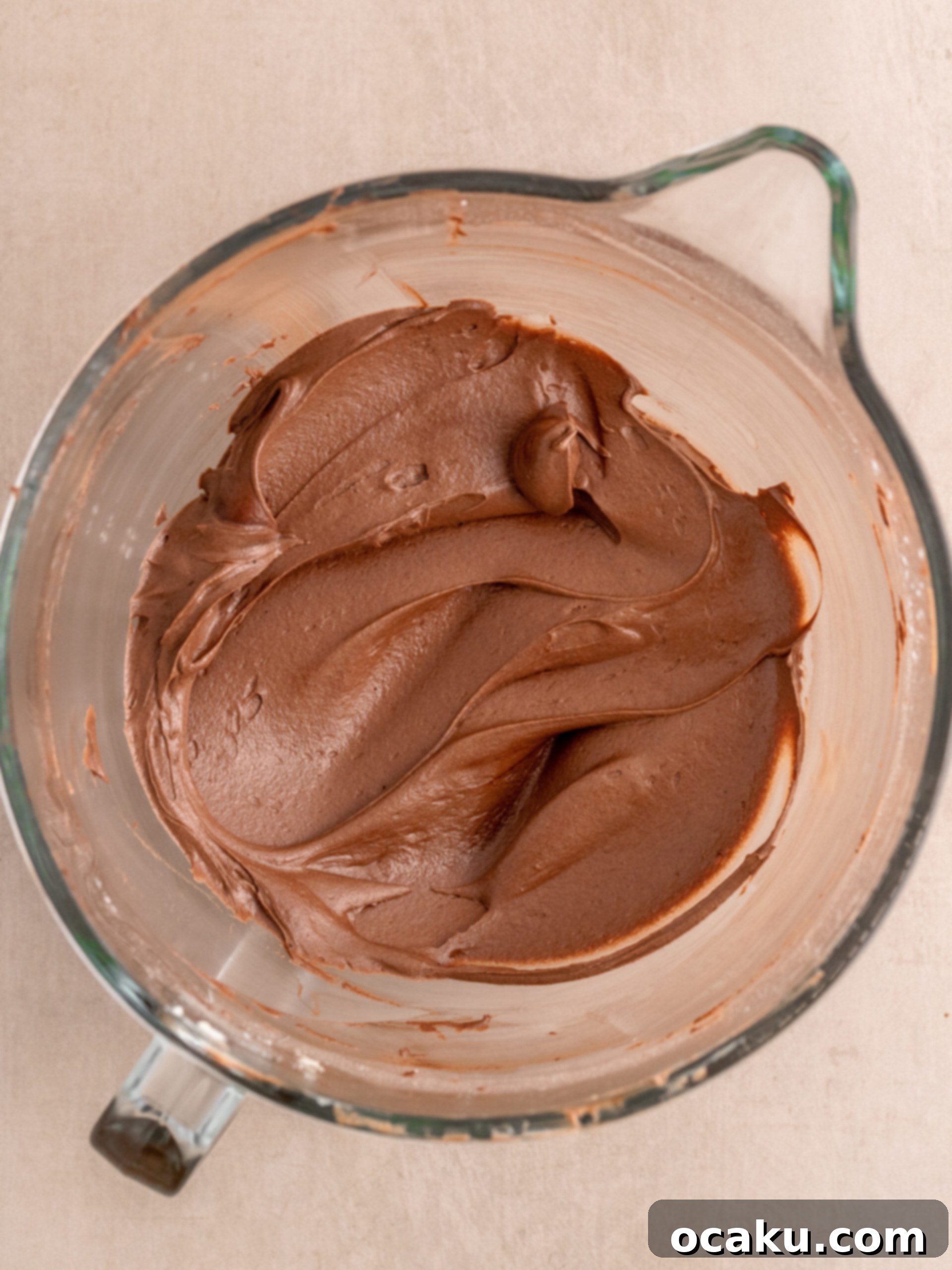 Creamy chocolate buttercream in a mixing bowl.