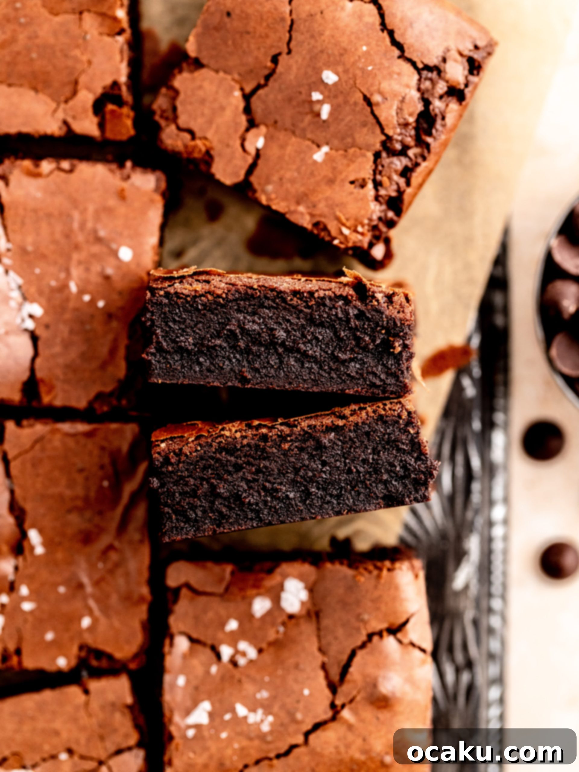 Close-up of a perfectly fudgy dairy-free brownie with a shiny, crackly top, inviting a bite.