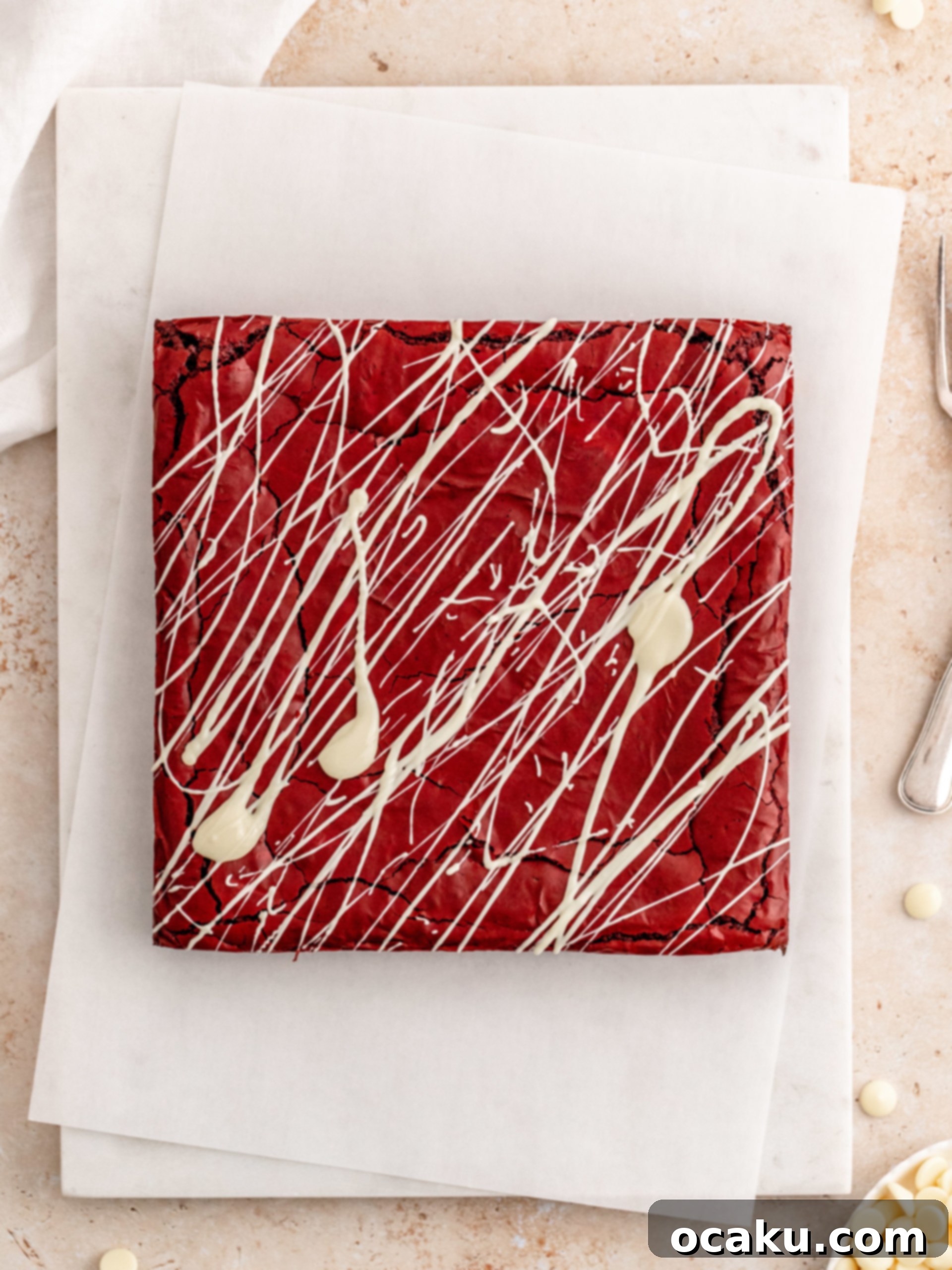 Decadent Red Velvet Brownies 6 Baked Red Velvet Brownies cooling on a rack, ready for white chocolate drizzle