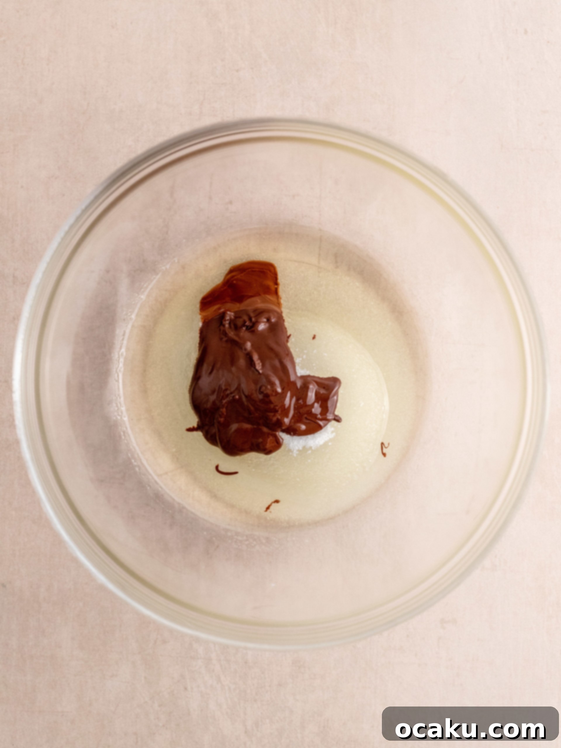 Wet ingredients being whisked in a bowl for Triple Chocolate Muffins.