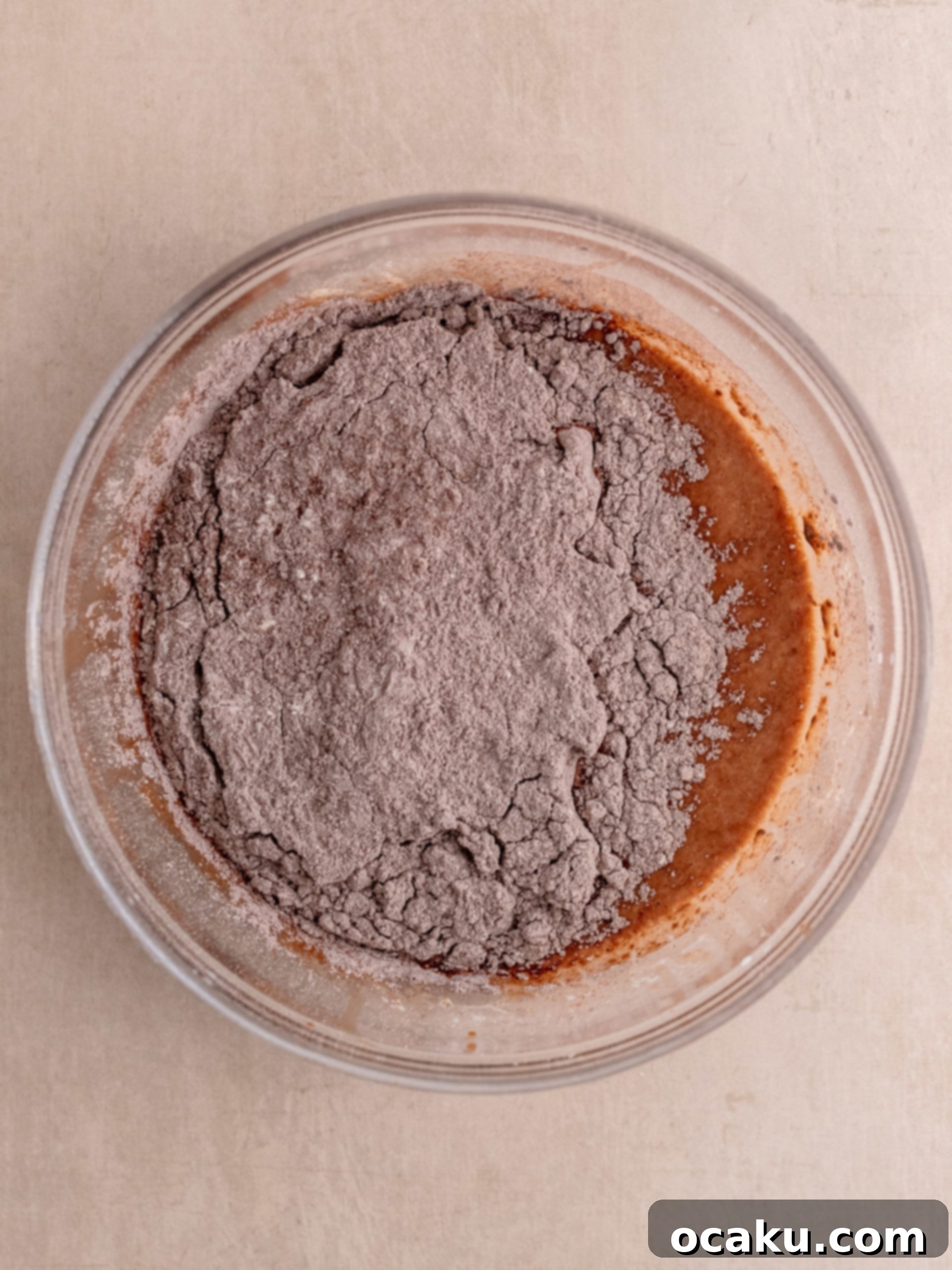 Muffin batter scooped into liners in a muffin tin.