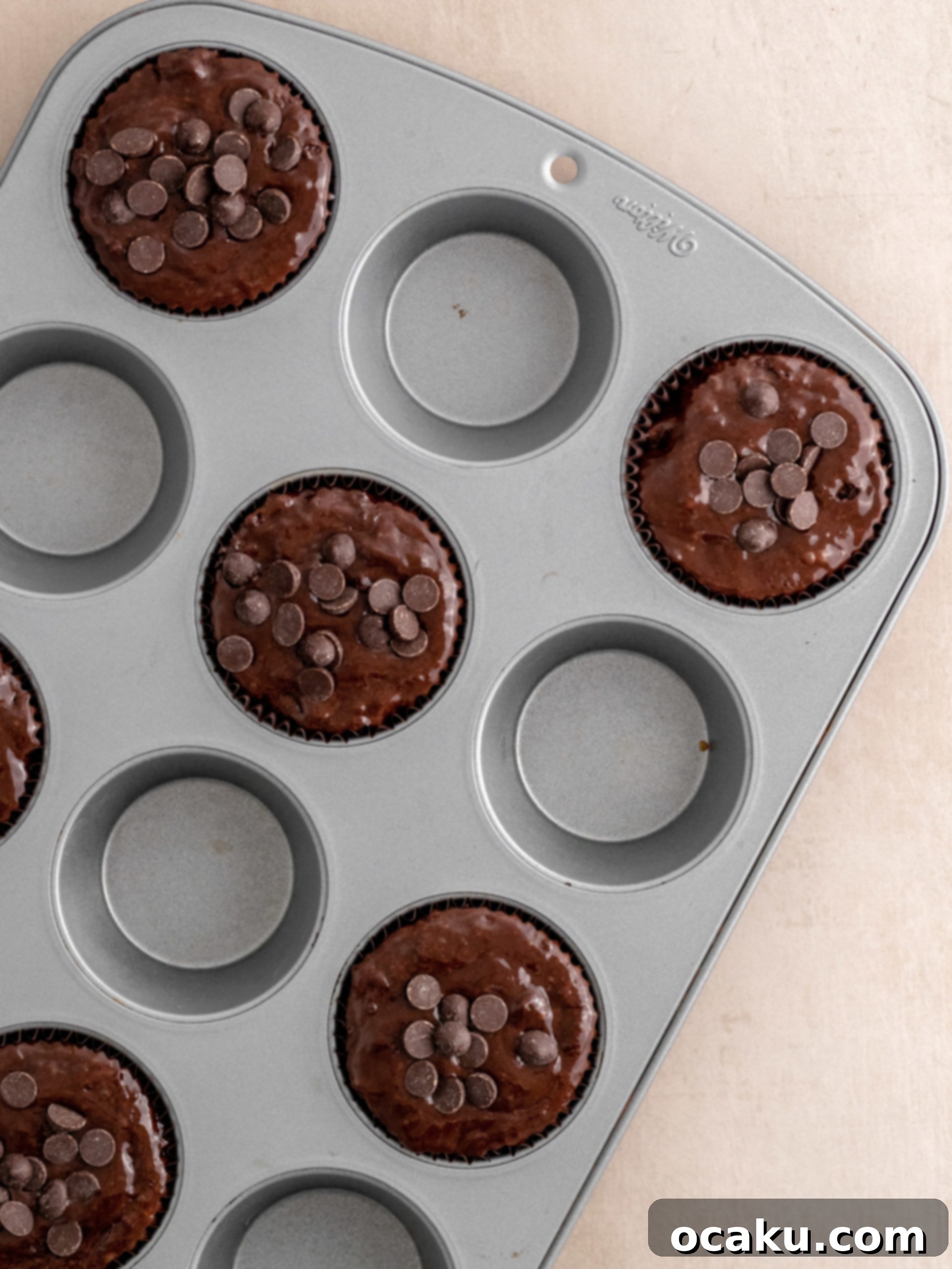 Freshly baked Triple Chocolate Muffins cooling on a wire rack.