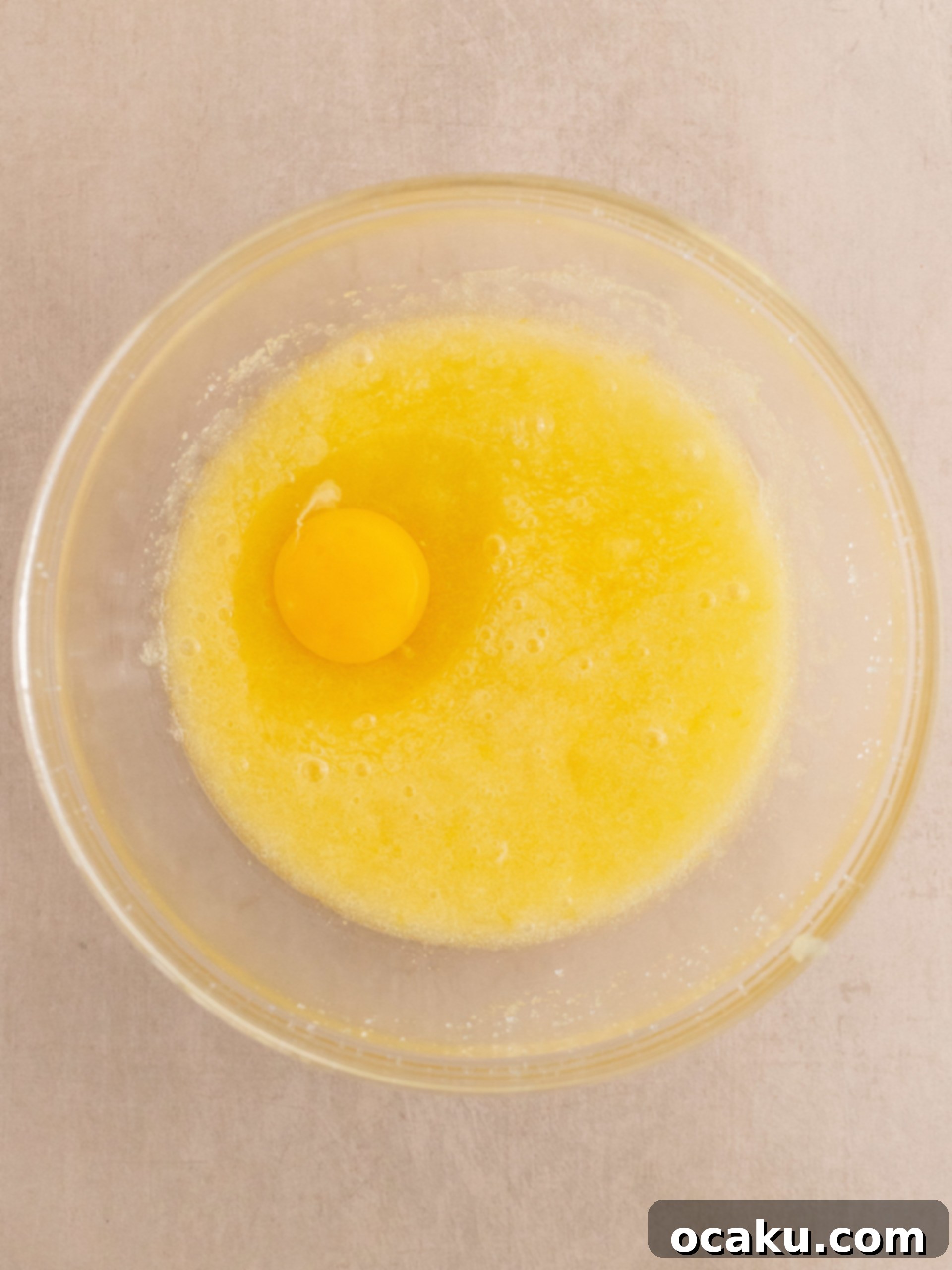 Zesty Lemon Poppy Seed Delights 4 Adding oil, sugar, and lemon zest to a mixer bowl