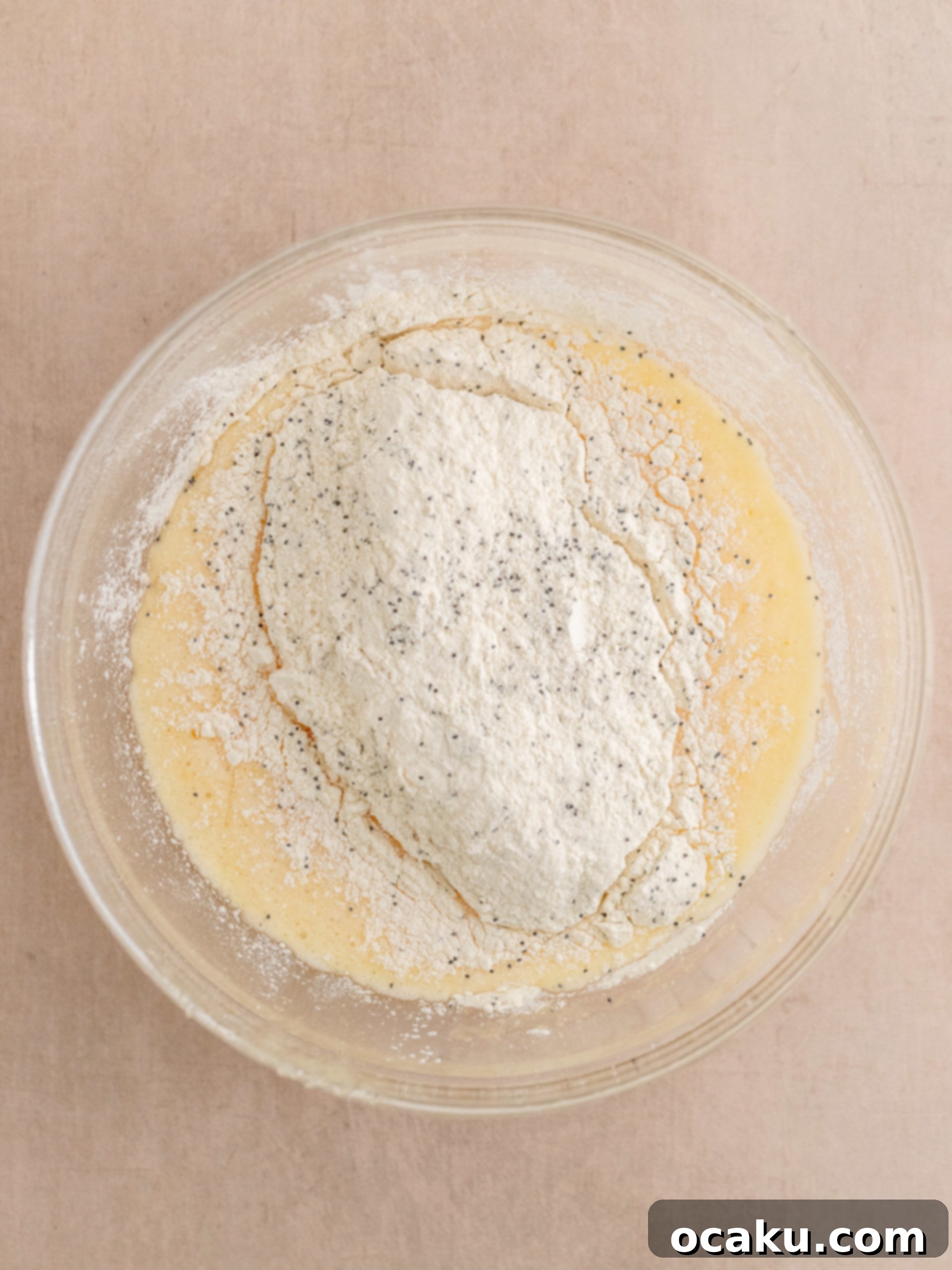 Zesty Lemon Poppy Seed Delights 5 Adding eggs one by one to the cupcake batter