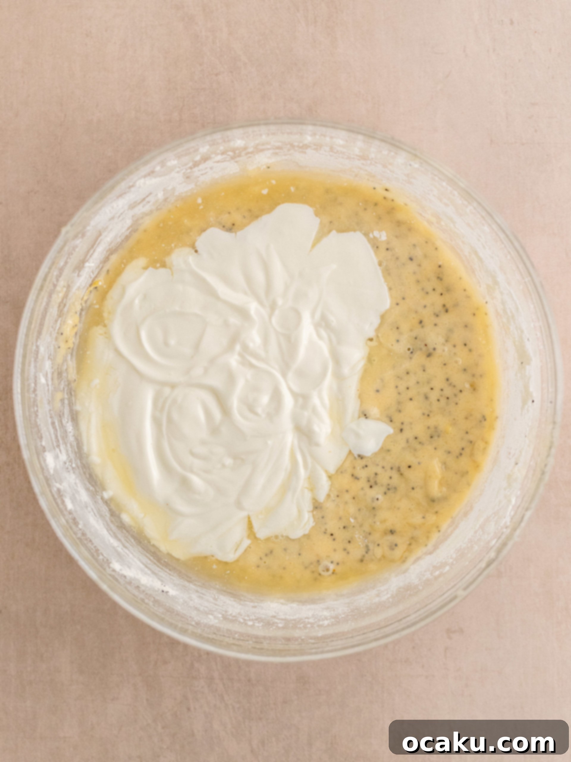 Zesty Lemon Poppy Seed Delights 6 Combining dry ingredients into wet for cupcakes