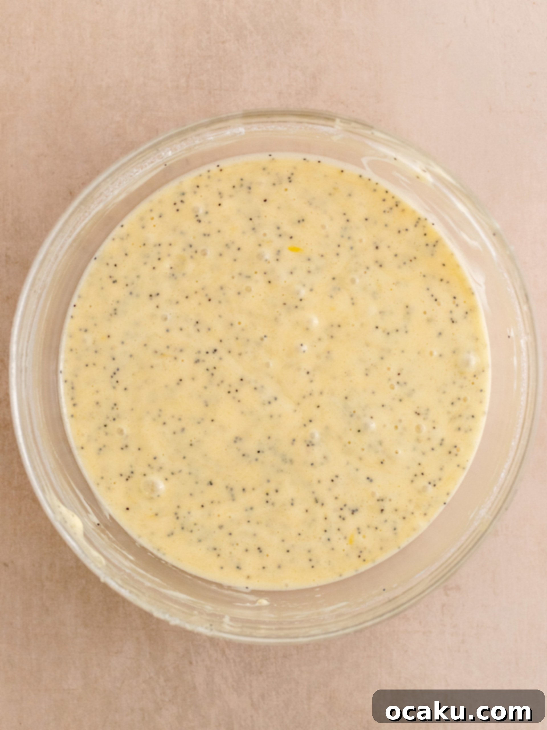 Zesty Lemon Poppy Seed Delights 7 Cupcake batter in liners, ready for baking