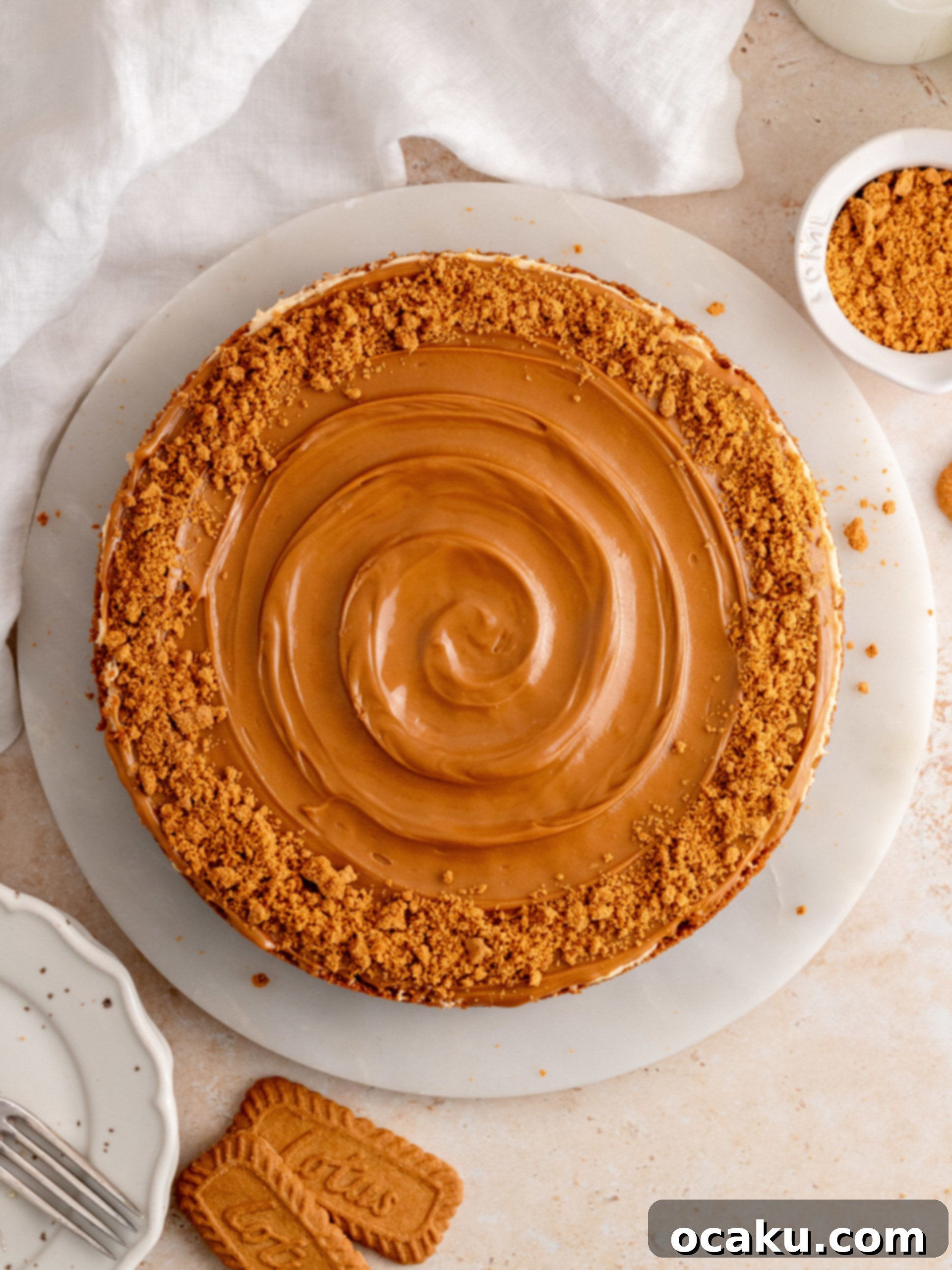 Caramelized Biscuit Cheesecake 10 Pouring melted Biscoff spread over the cheesecake