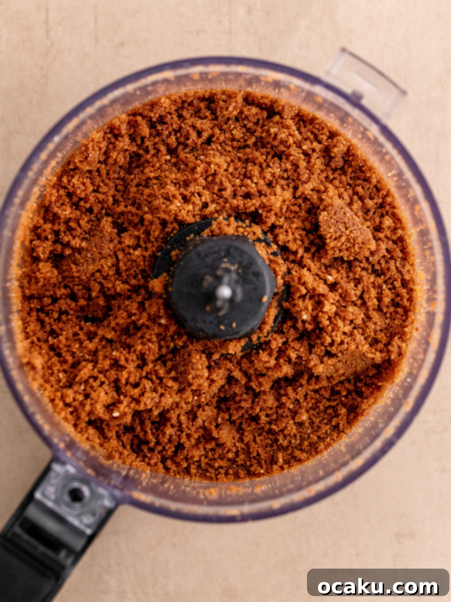 Caramelized Biscuit Cheesecake 3 Crushing Biscoff cookies in a food processor