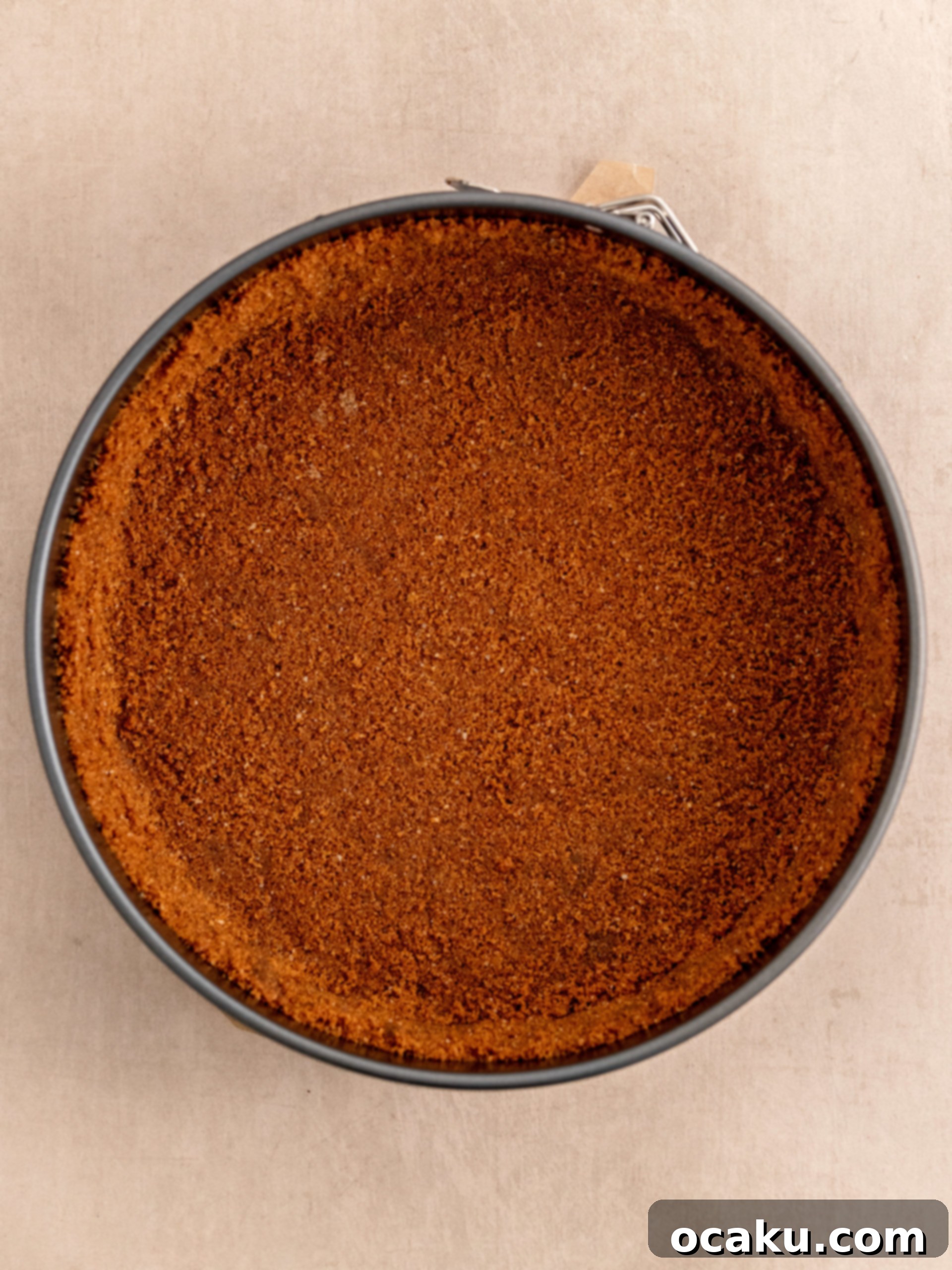 Caramelized Biscuit Cheesecake 4 Pressing Biscoff cookie crust into a springform pan