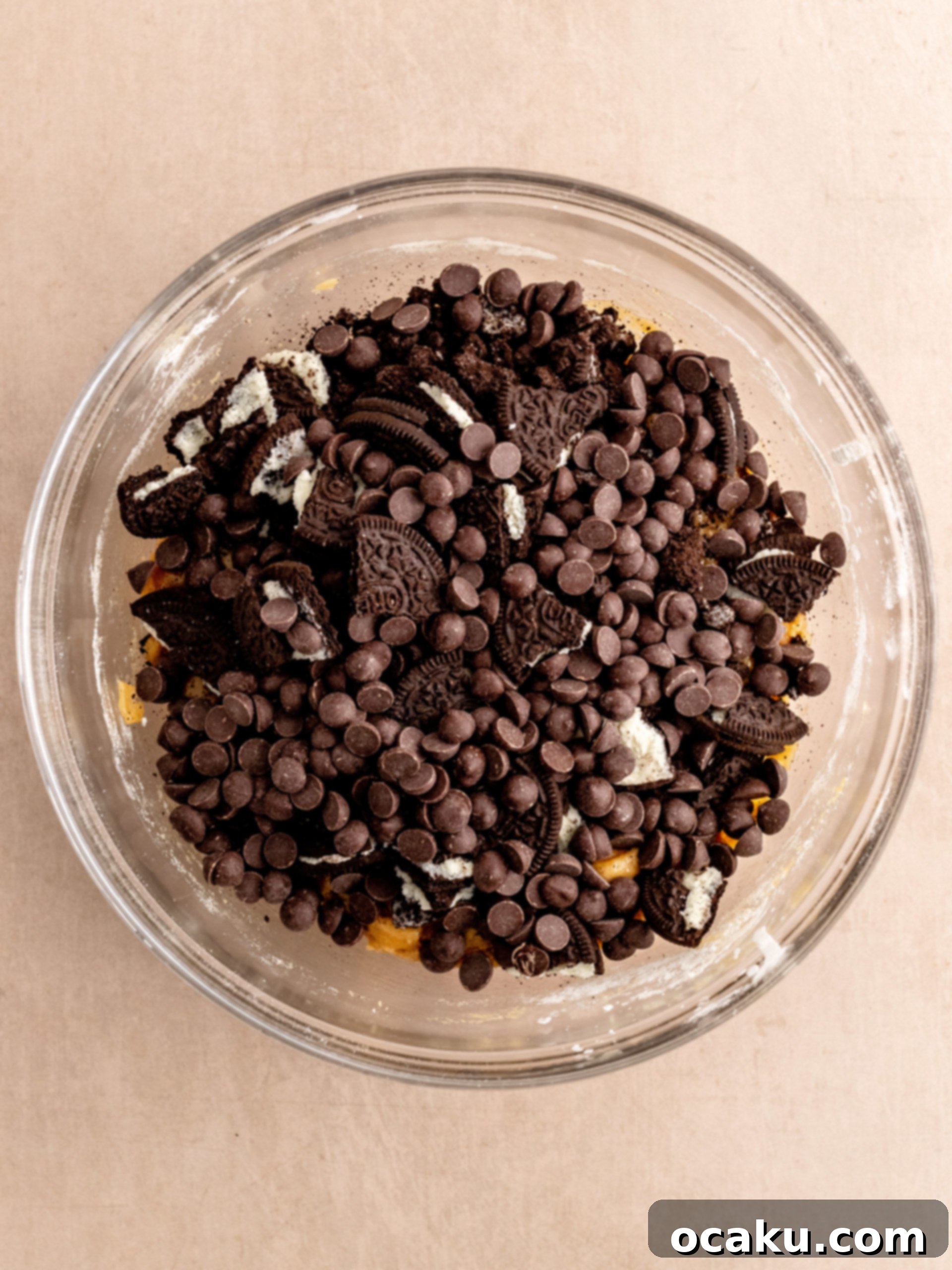 Crushing Oreo cookies in a plastic bag for crumbs and breaking them into chunks.