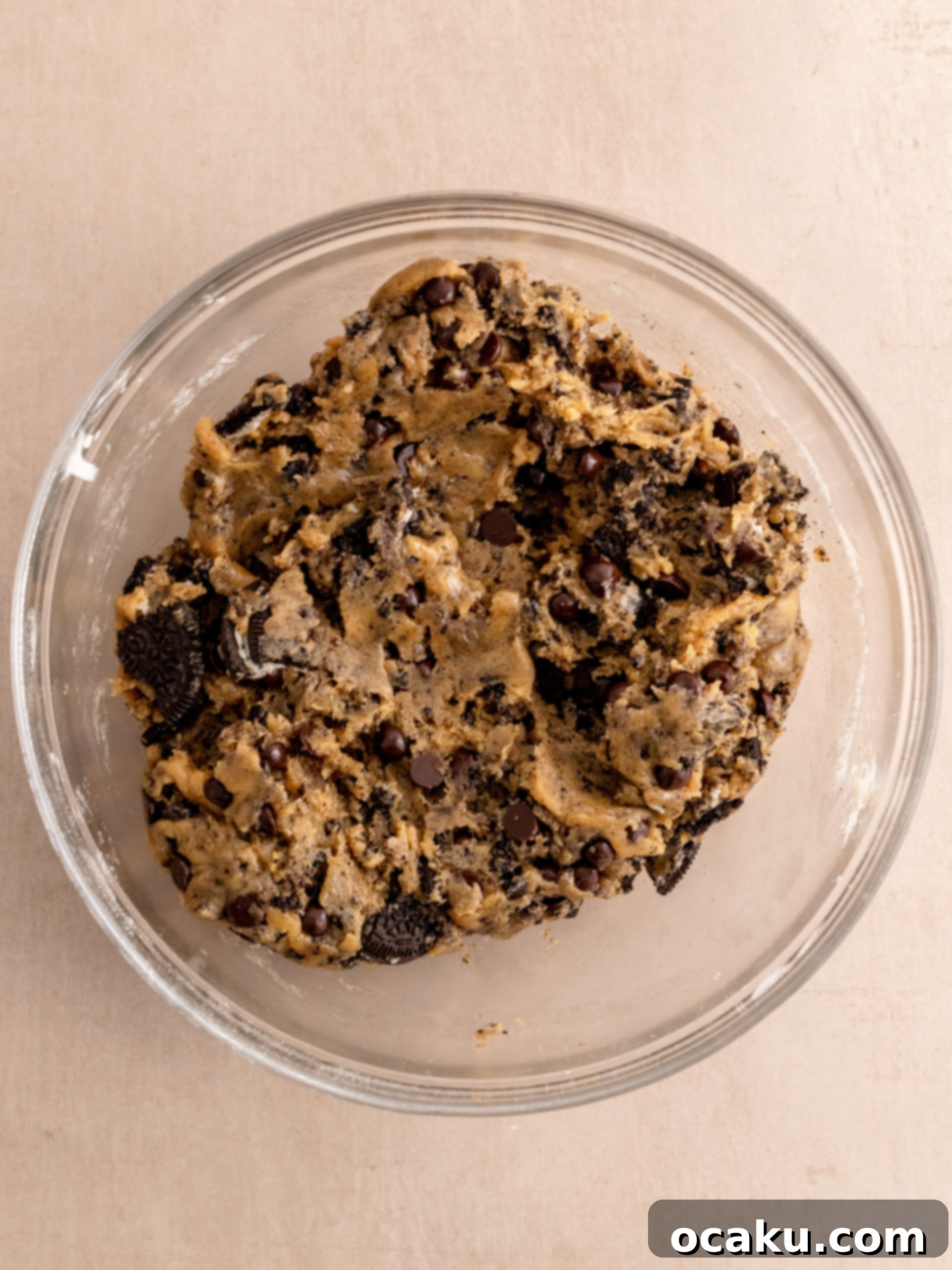 Scooped Oreo Chocolate Chip Cookie dough balls chilling on a tray.