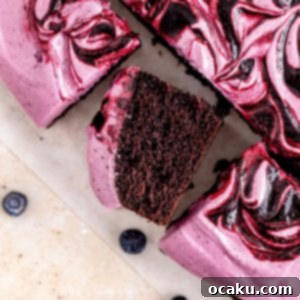 Blueberry Midnight Dream 11 Blueberry Chocolate Cake topped with purple frosting and fresh blueberries