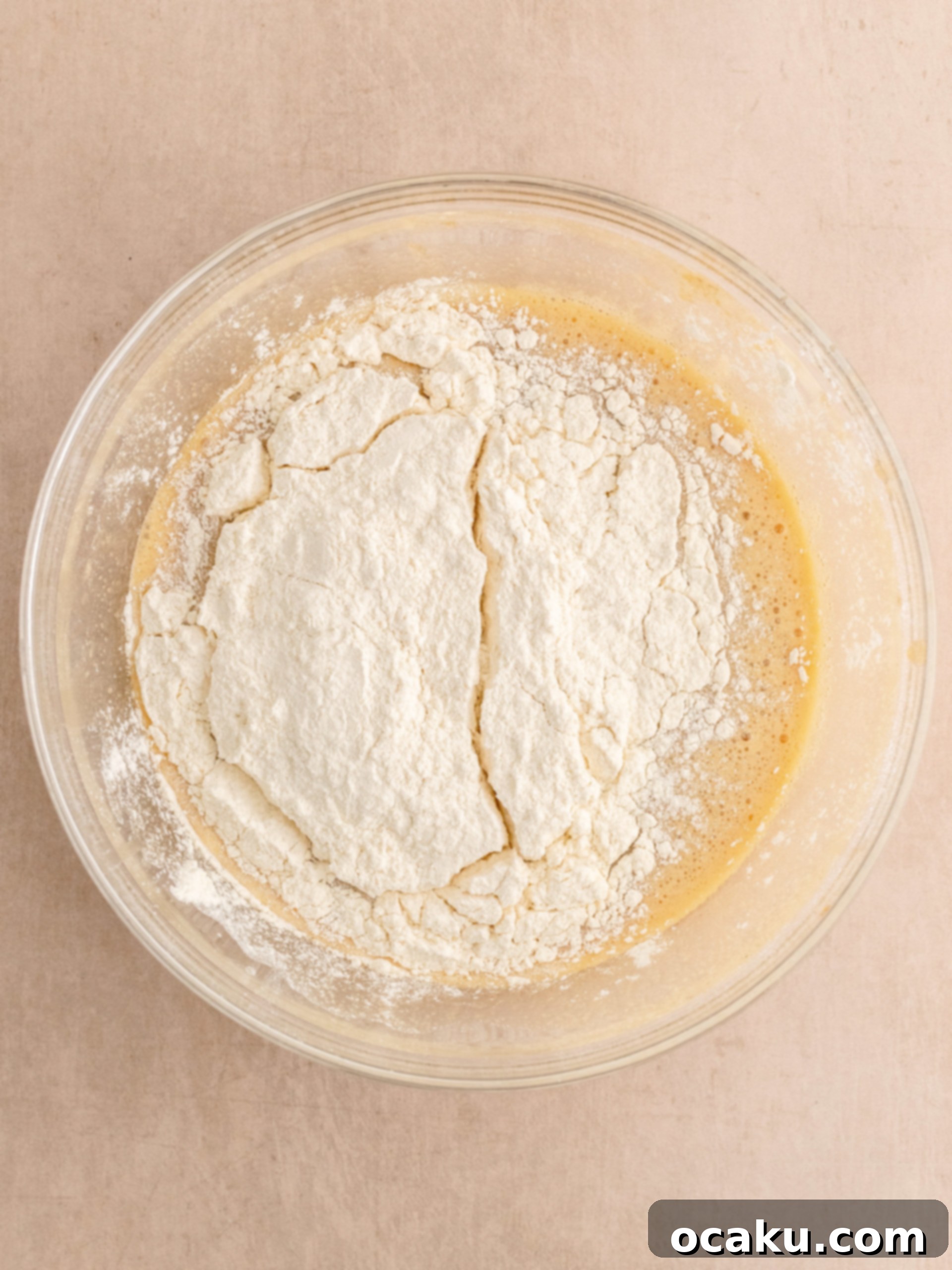 Step-by-step image of adding eggs to blondie batter