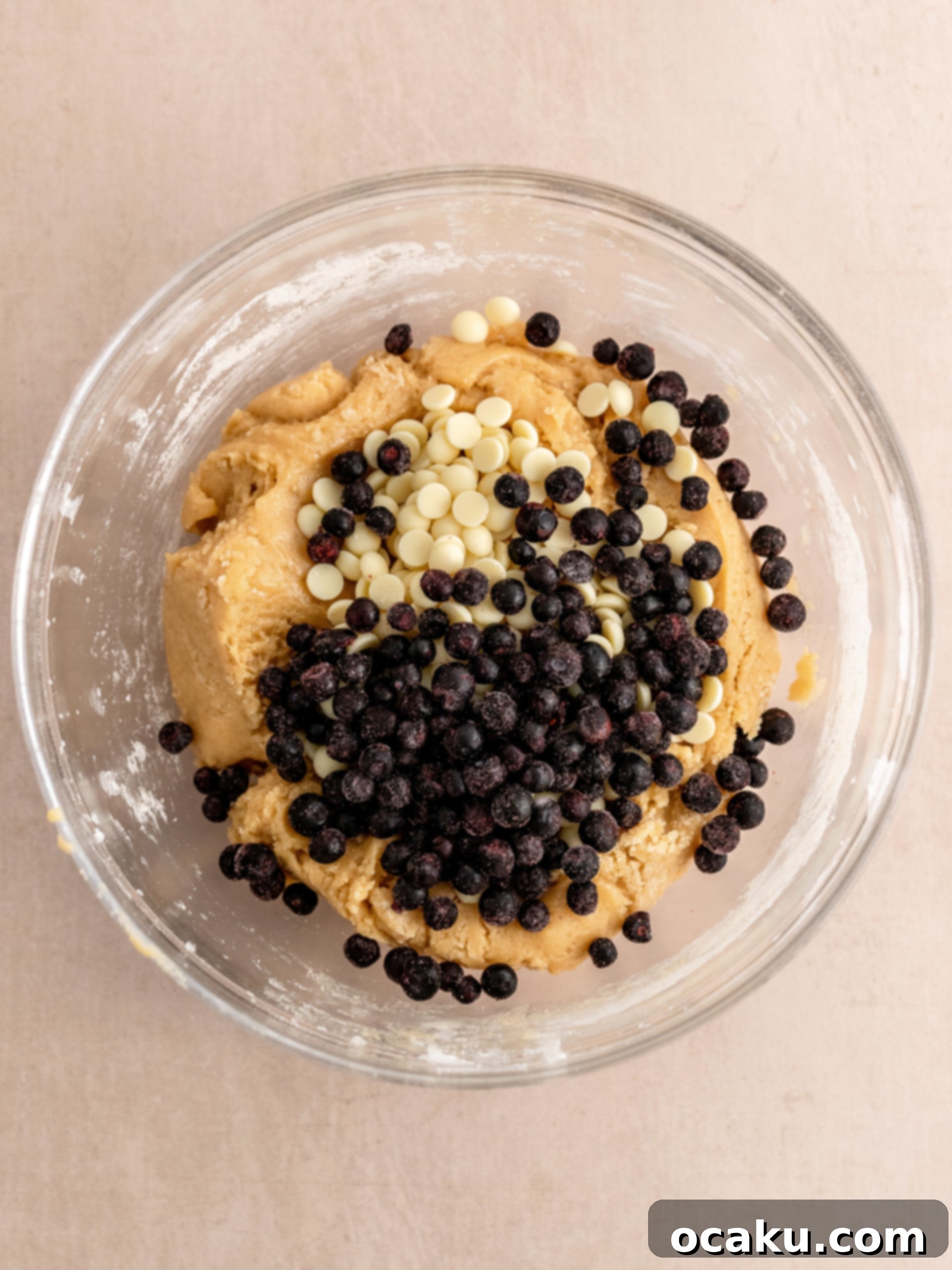 A second image of unbaked cookie dough balls on a baking sheet, ready for chilling.