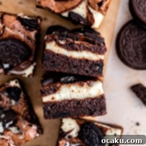 A perfectly sliced Oreo Cheesecake Brownie, showcasing the fudgy layers and cheesecake swirl.