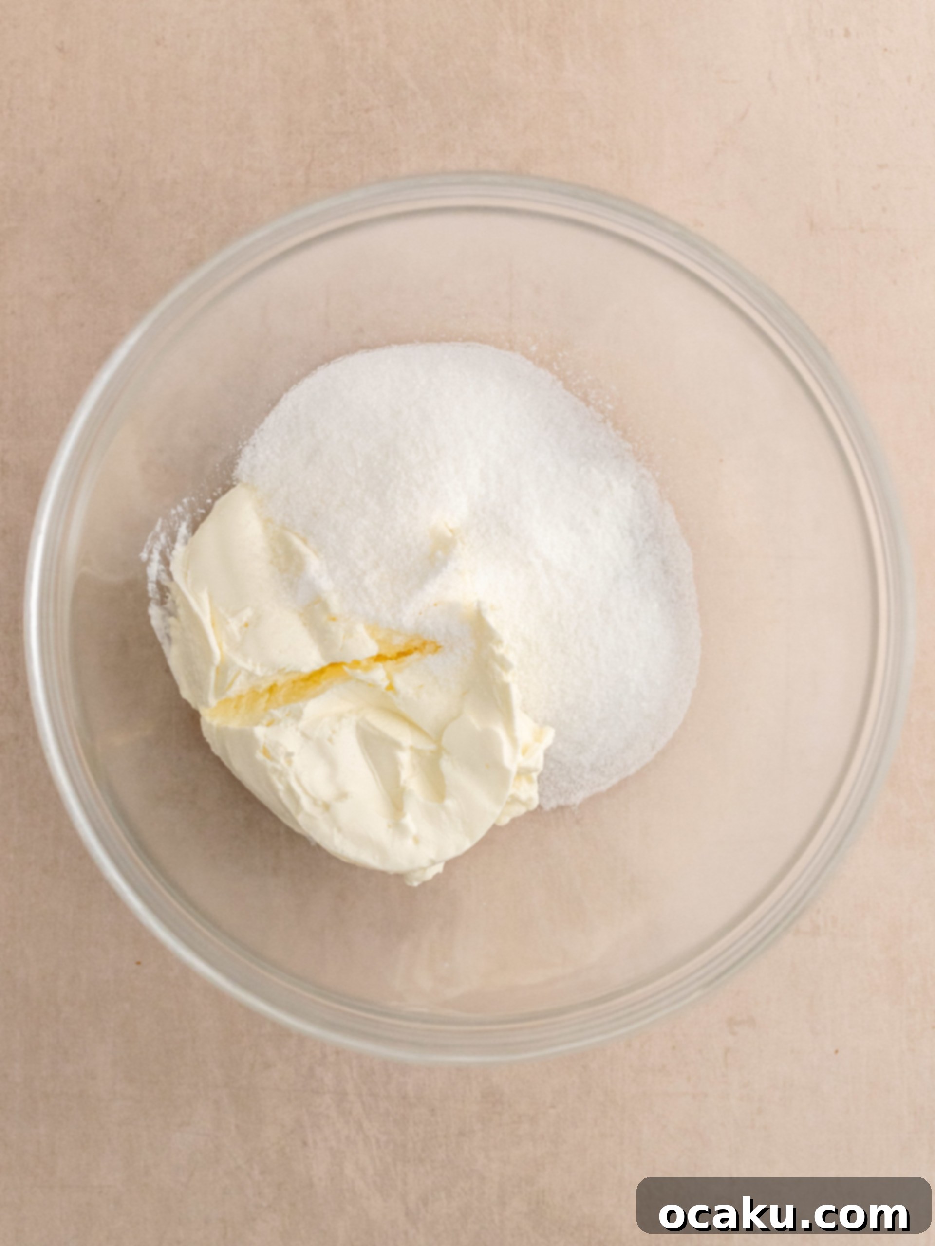 Mixing the cream cheese, sugar, and cornstarch for the cheesecake layer.