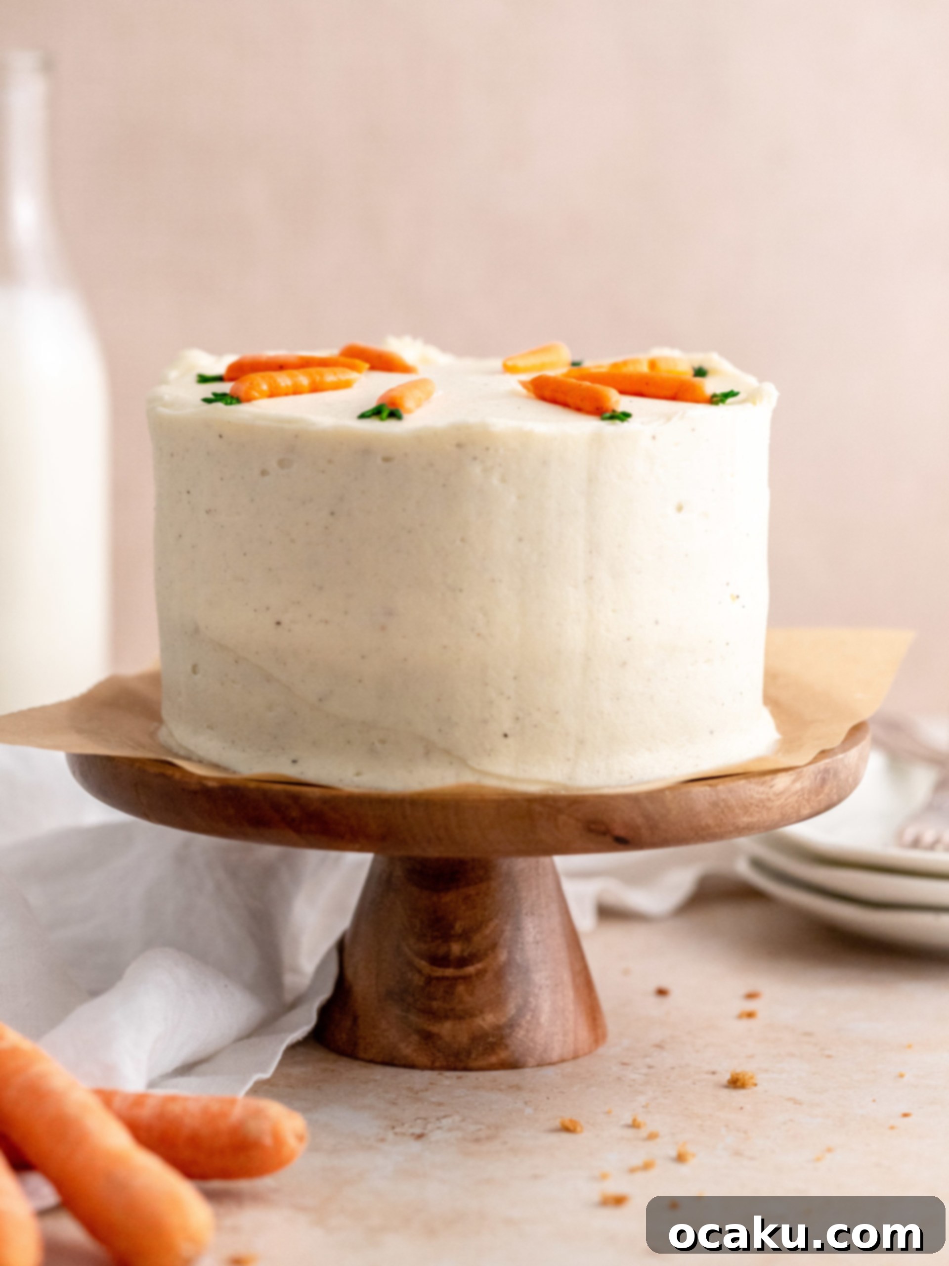 A slice of mini carrot cake with cream cheese frosting, showing the moist layers and decorative piping.