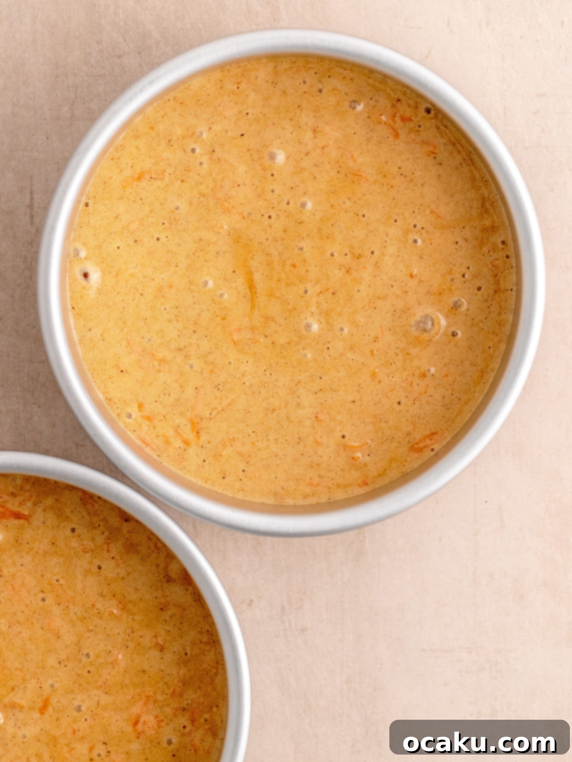 Freshly grated carrots being added to the cake batter.