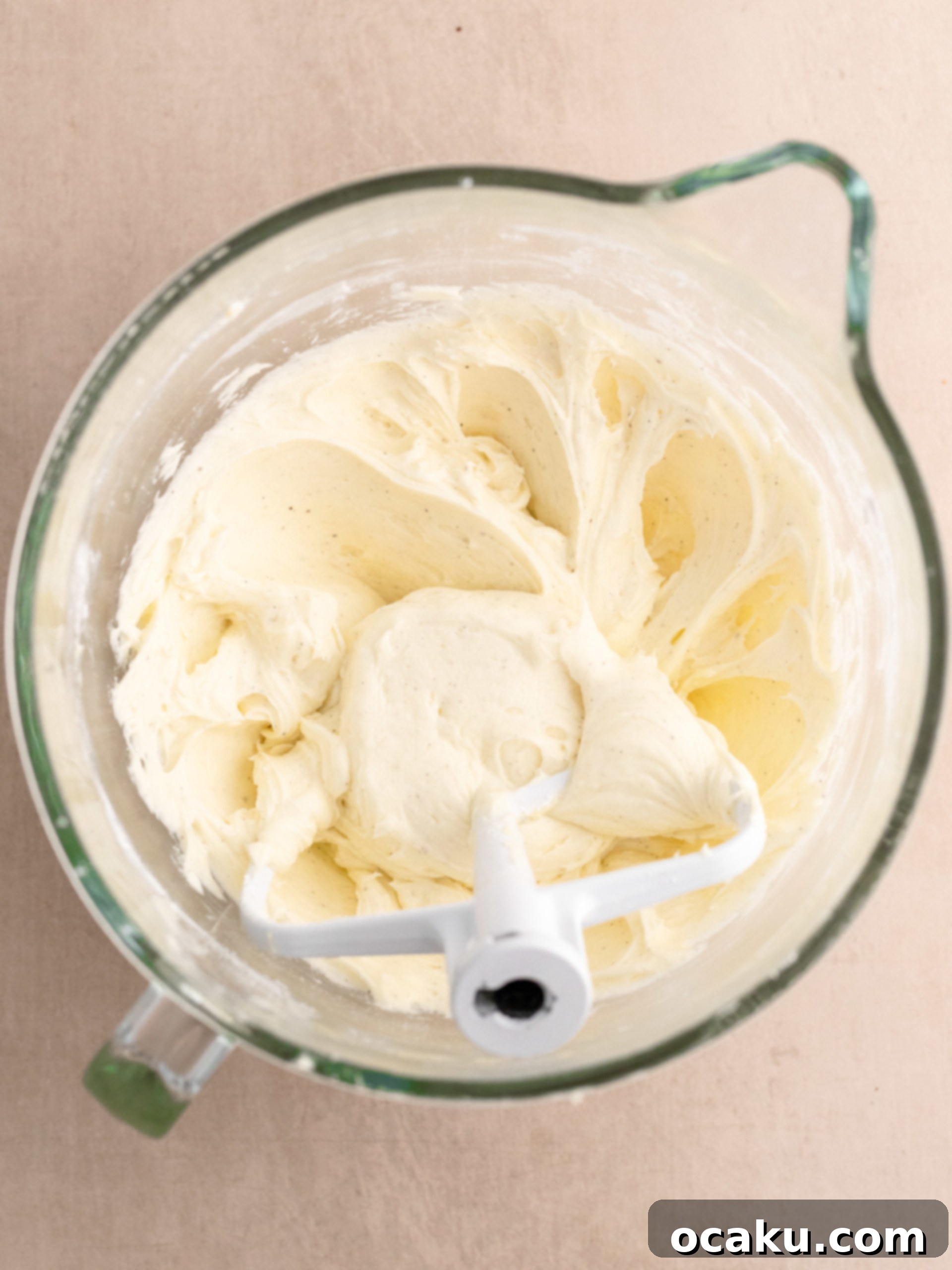 A stand mixer creaming butter until light and fluffy for the cream cheese frosting.