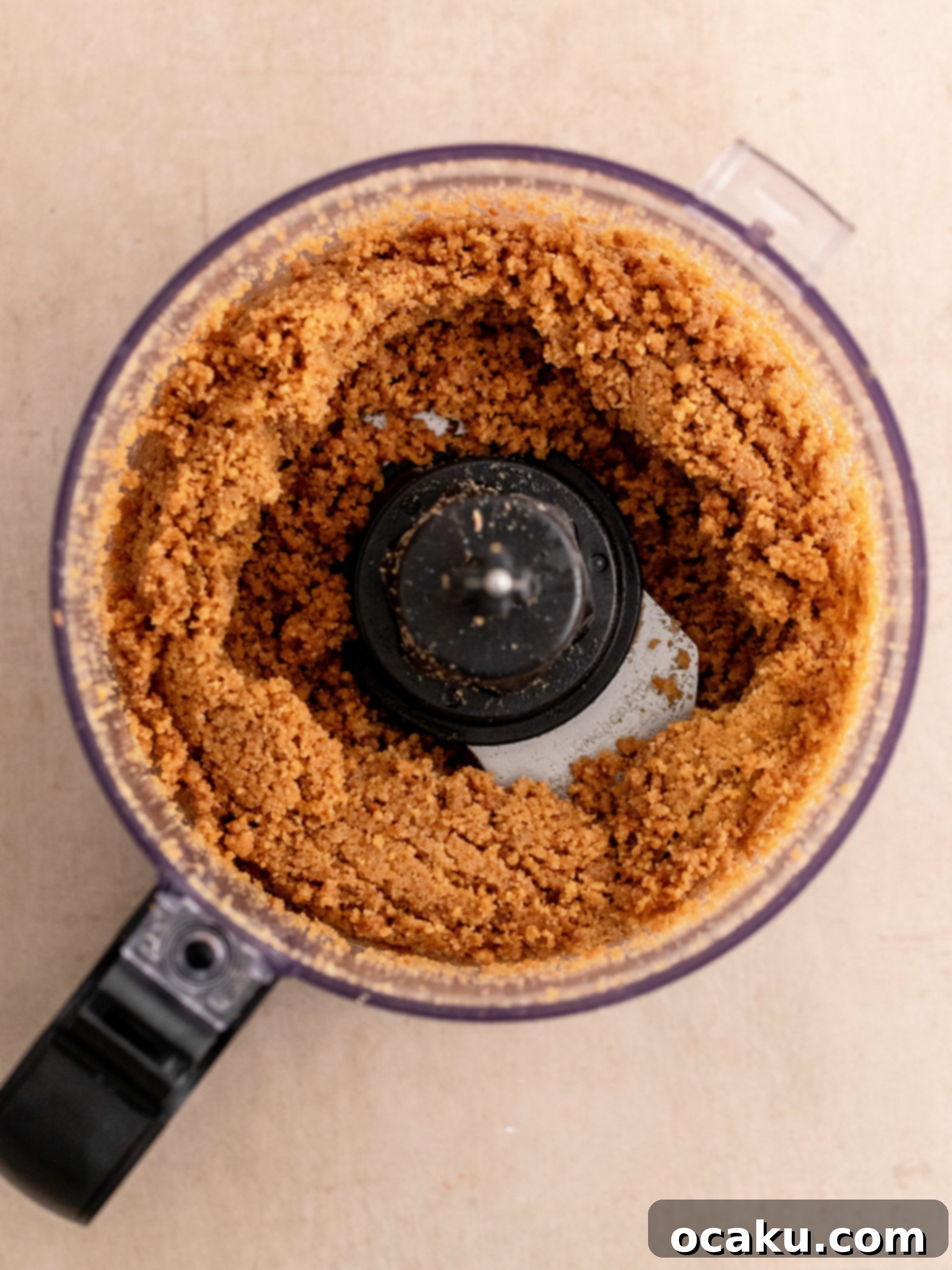 Melted butter being added to the cookie and Daim crumb mixture.