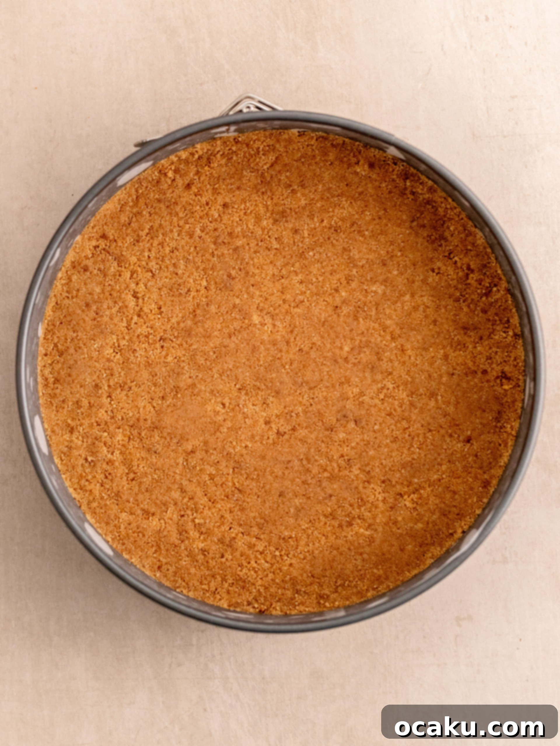 The cookie and Daim crust being pressed firmly into the springform pan.