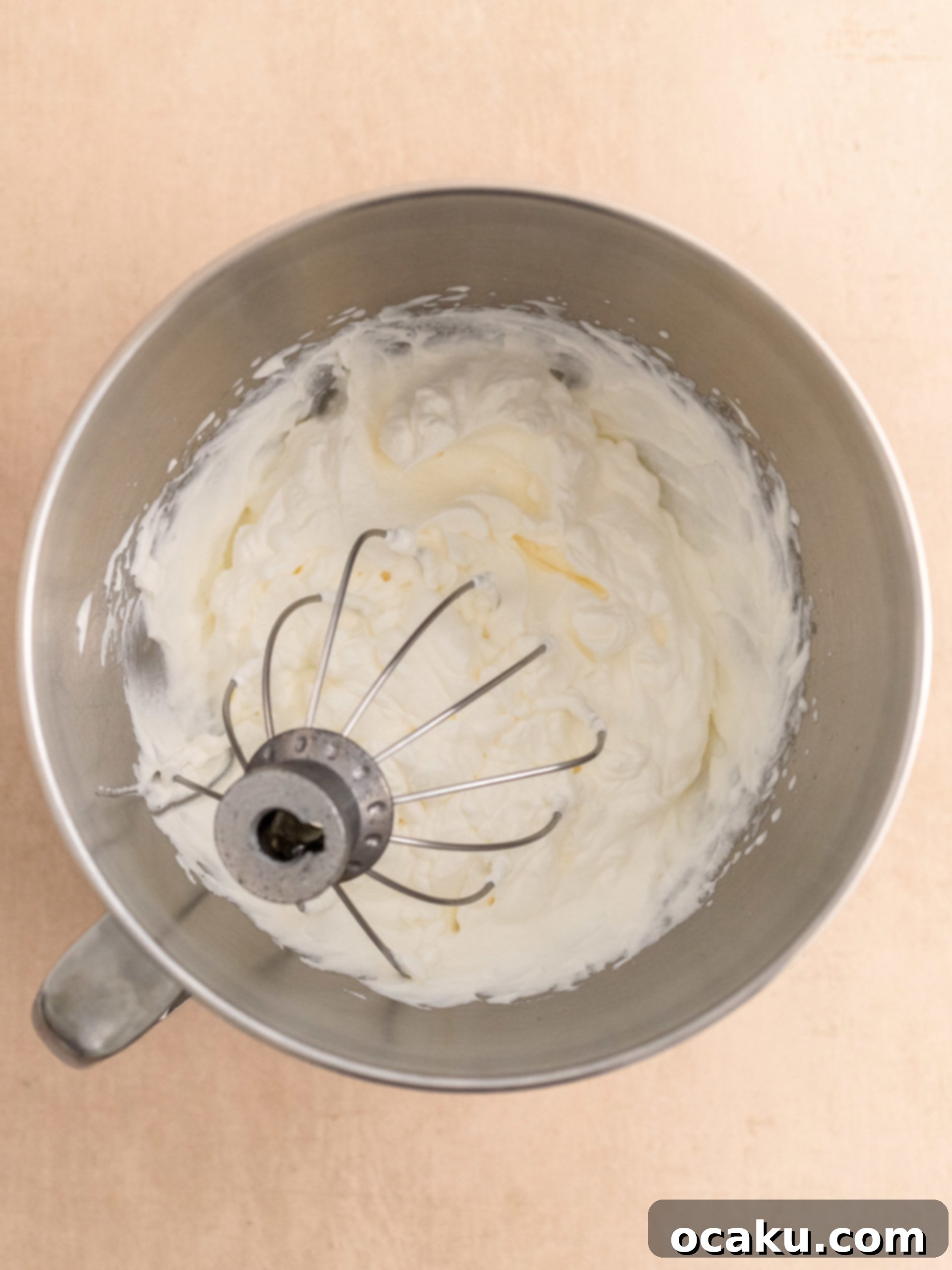 The creamy cheesecake filling being smoothed into the crust.