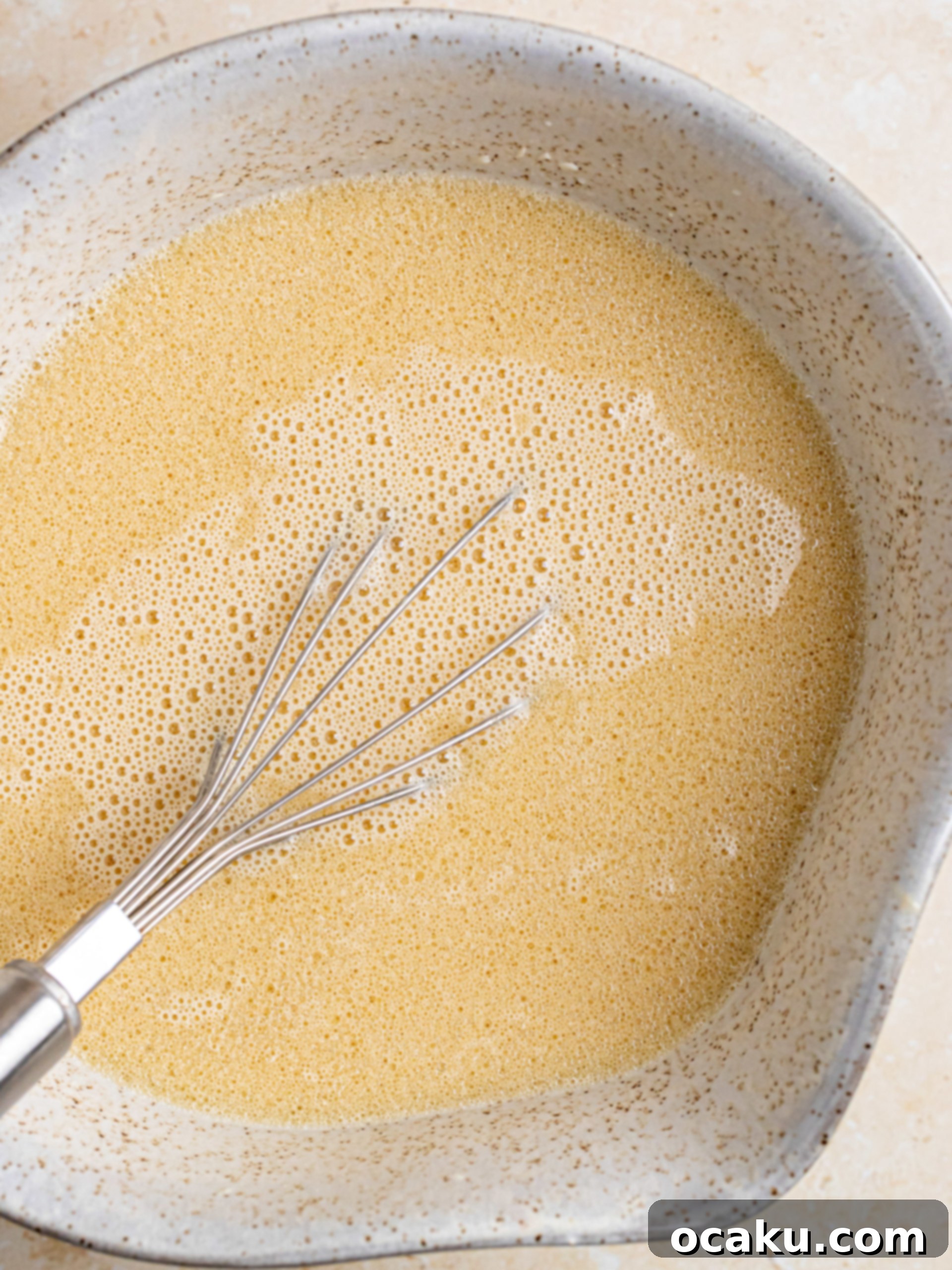 Three baked chocolate cake layers cooling on a wire rack.