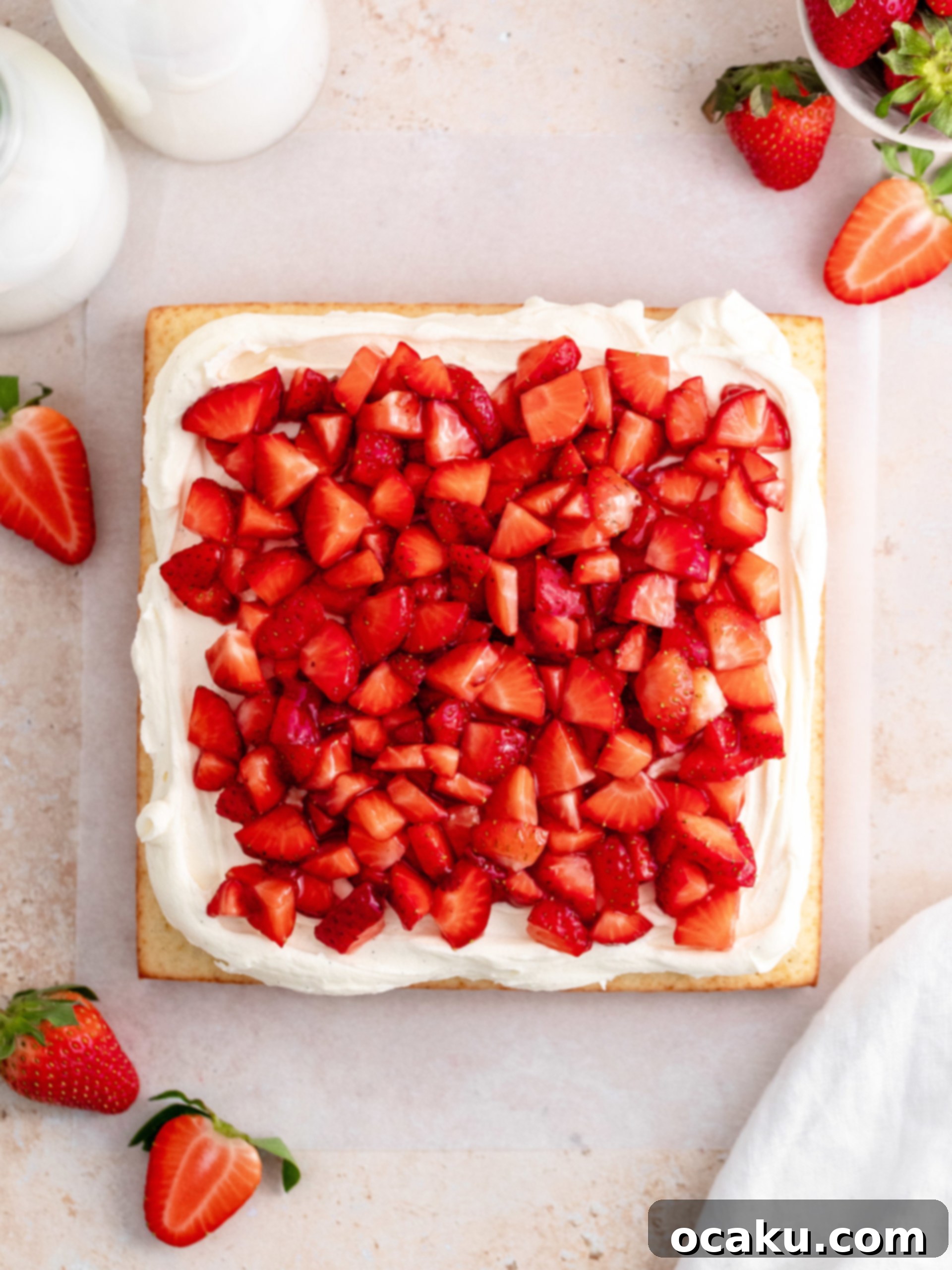 Slice of Strawberry Vanilla Cake revealing moist vanilla layers and creamy frosting.