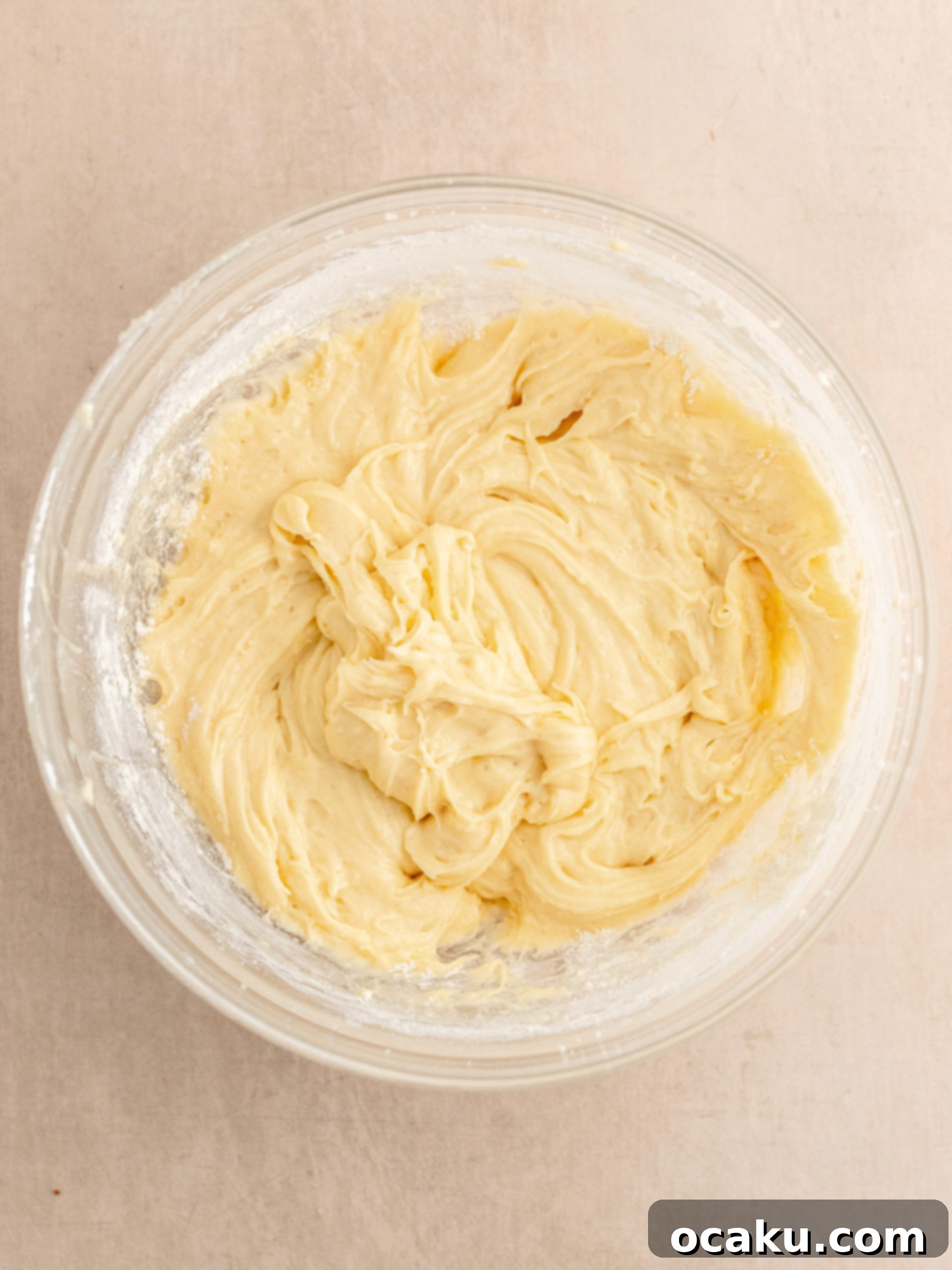 Adding dry ingredients to the wet mixture.