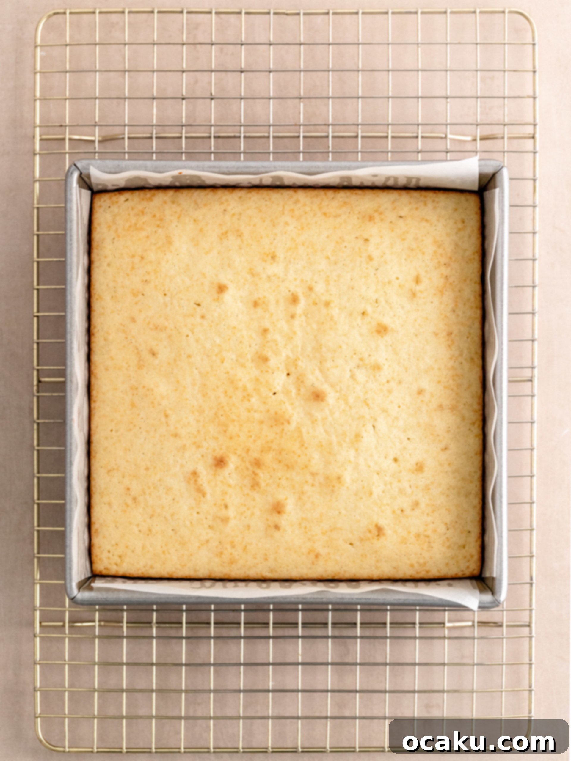 Pouring cake batter into a prepared square pan.