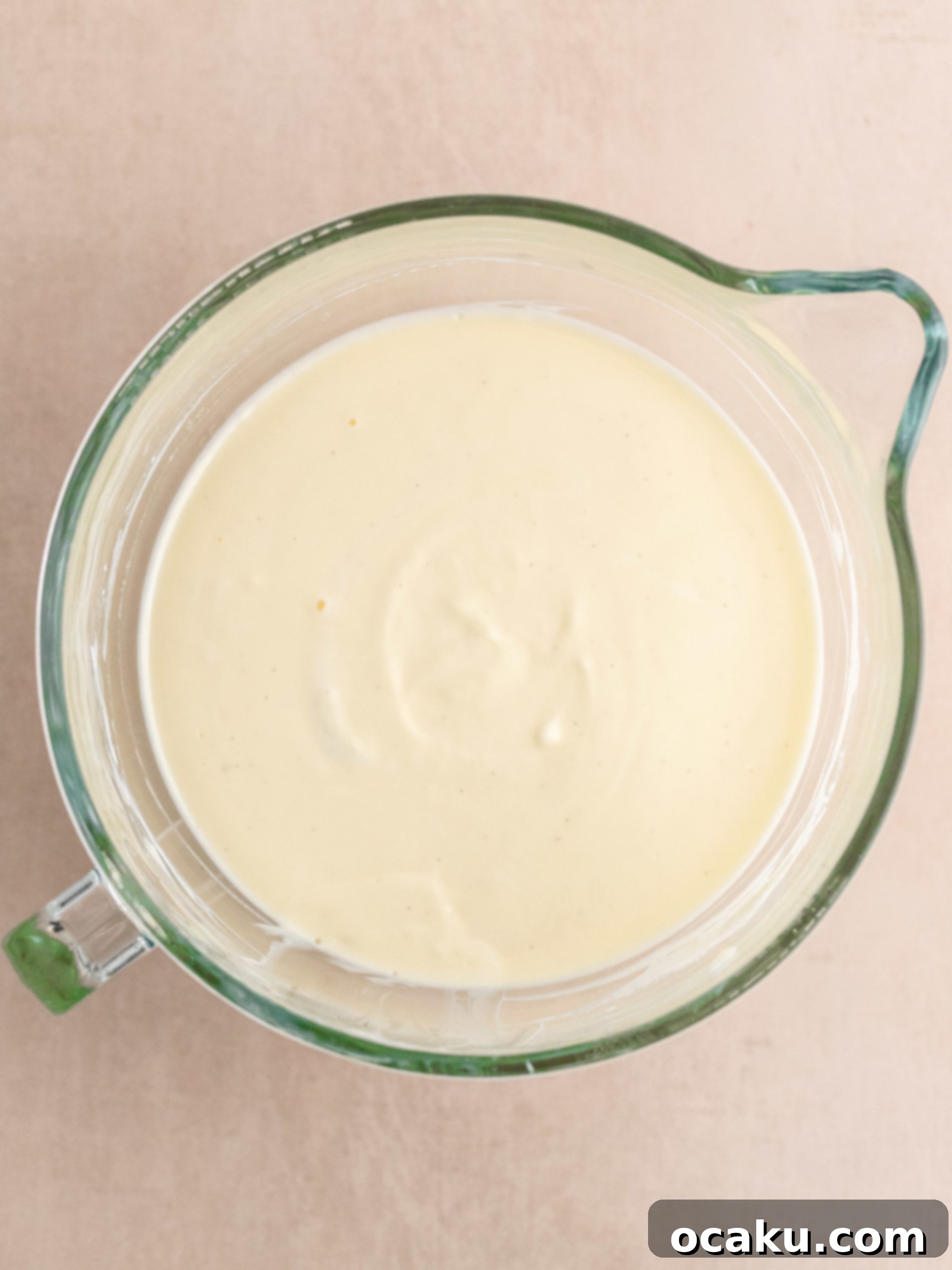 Melted butter being added to cookie crumbs in a food processor