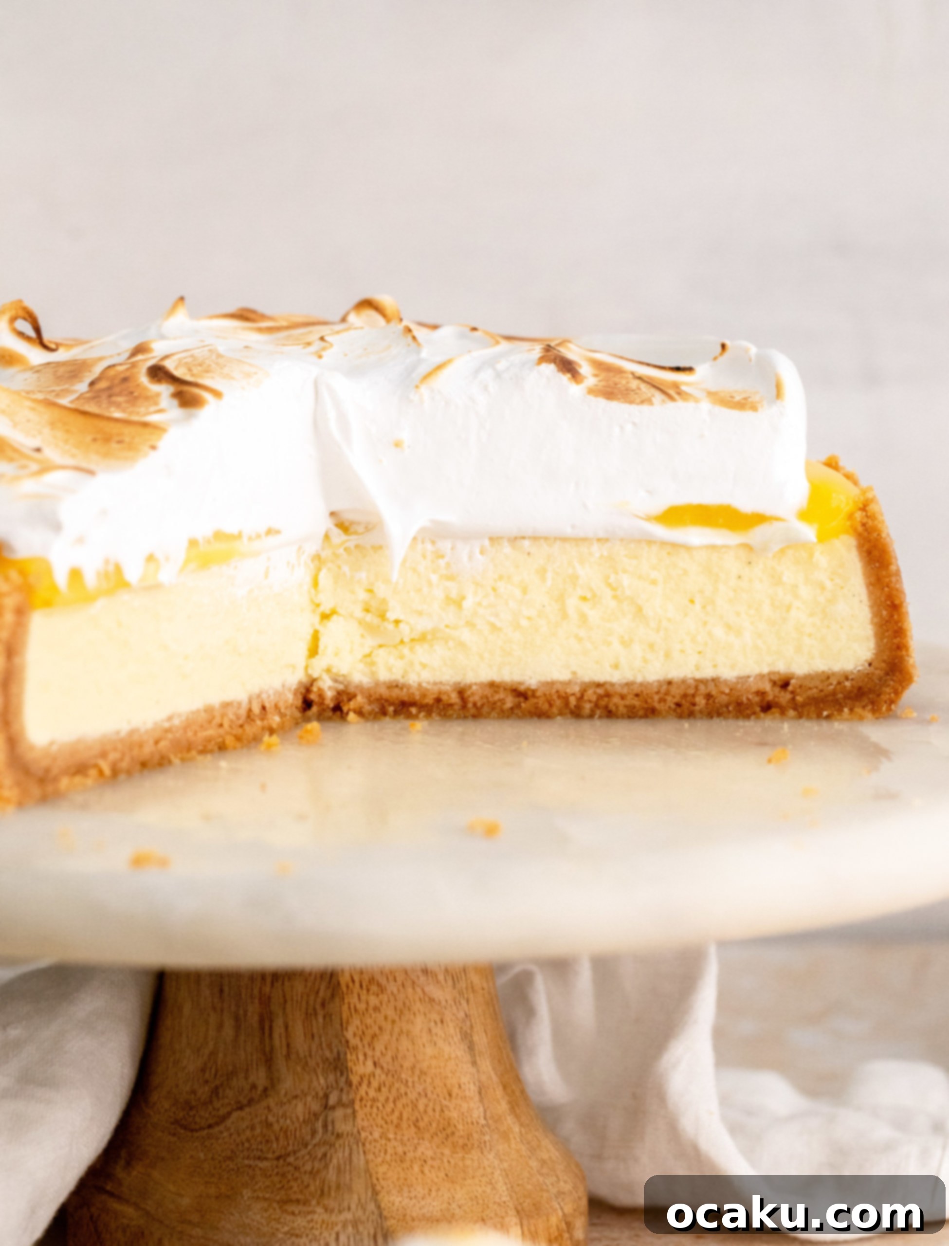 Lemon Meringue Cheesecake being torched to brown the meringue