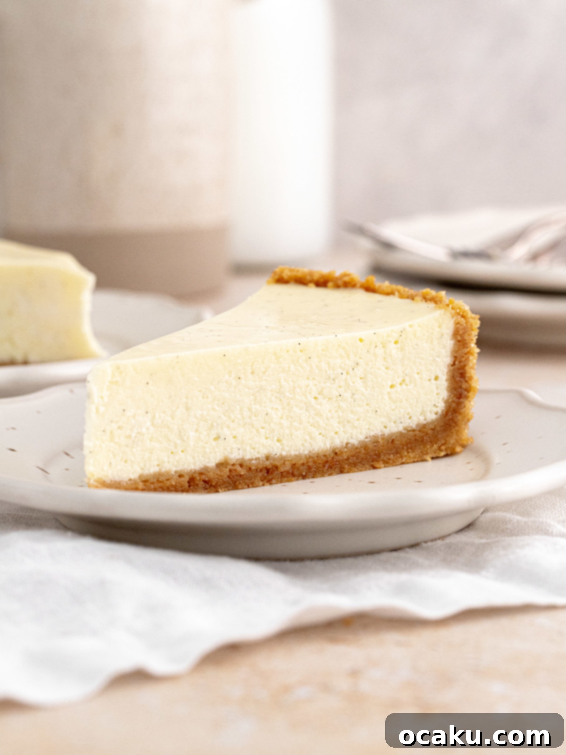 Decadent Vanilla Cheesecake 2 A slice of creamy vanilla cheesecake with a graham cracker crust, topped with fresh strawberries