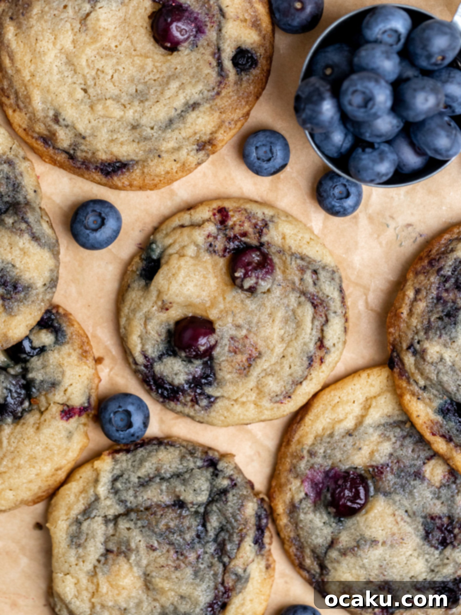 Berry Bliss Cookies 3 Close-up of a stack of freshly baked blueberry cookies, showing their soft centers and visible blueberries and jam swirls.