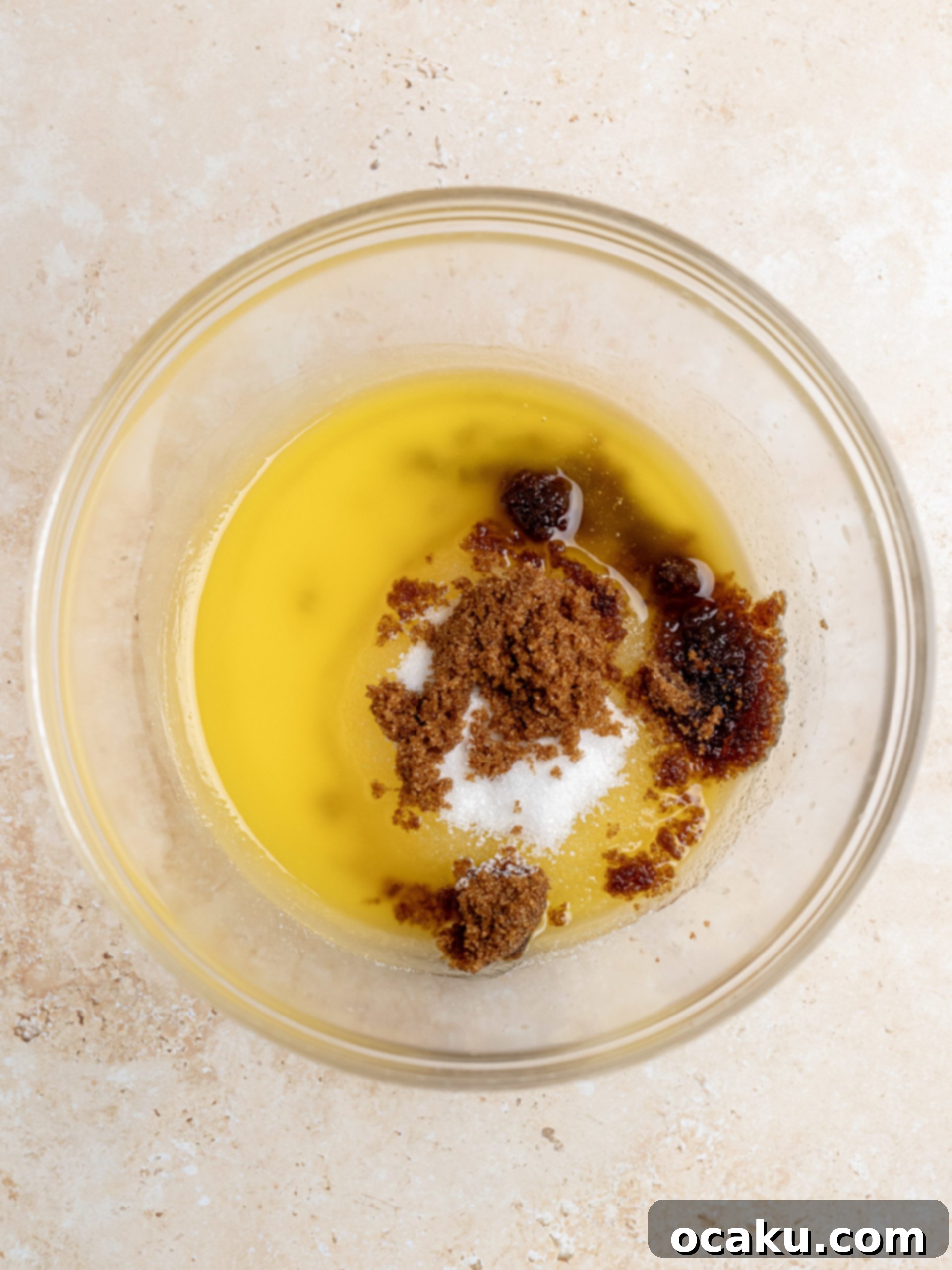 Berry Bliss Cookies 4 Mixing melted butter and sugars in a bowl with a rubber spatula for blueberry cookies.