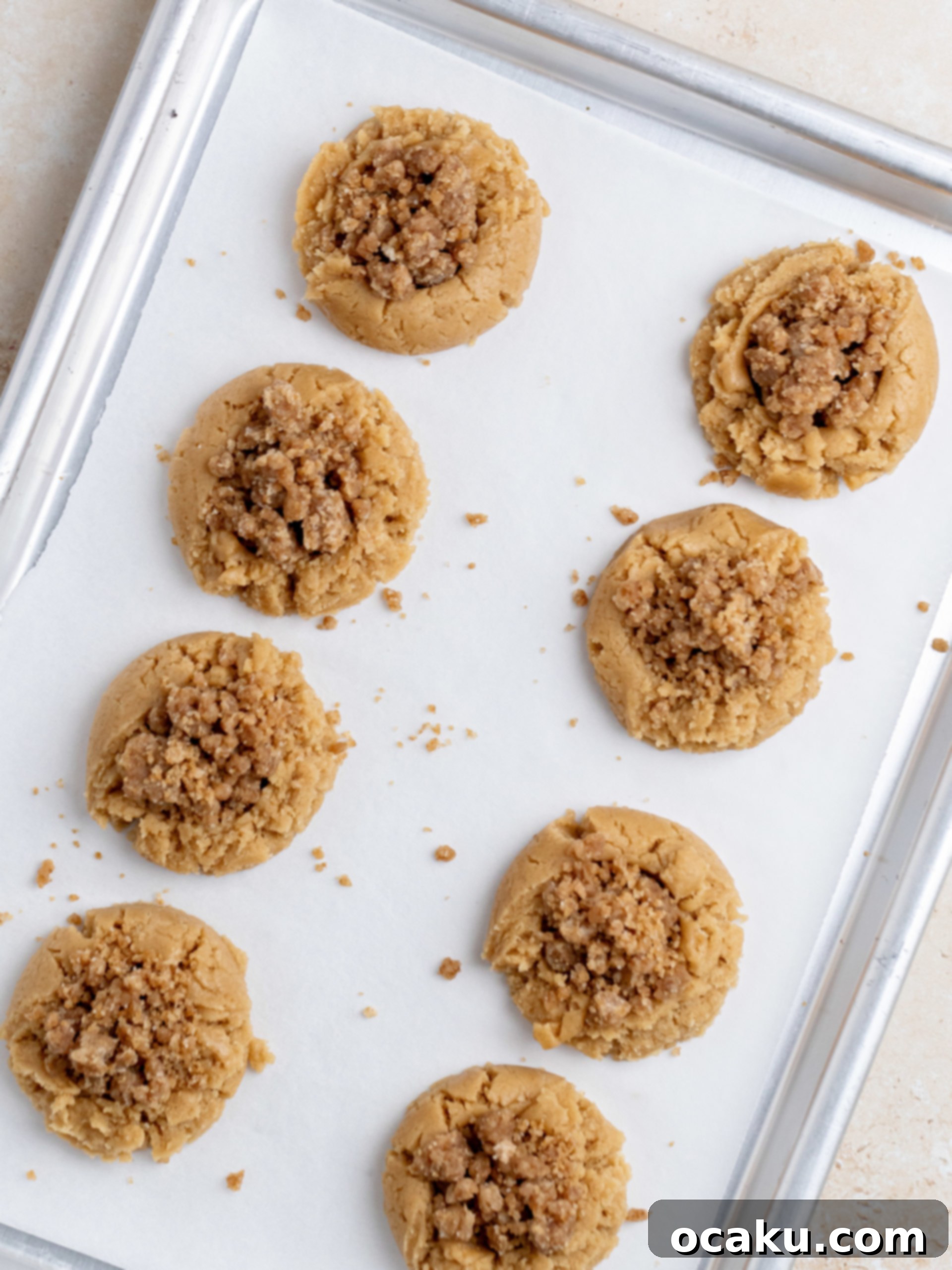 Streusel Coffee Cake Cookies 7 Close-up of a Coffee Cake Cookie on a cooling rack with glaze being drizzled