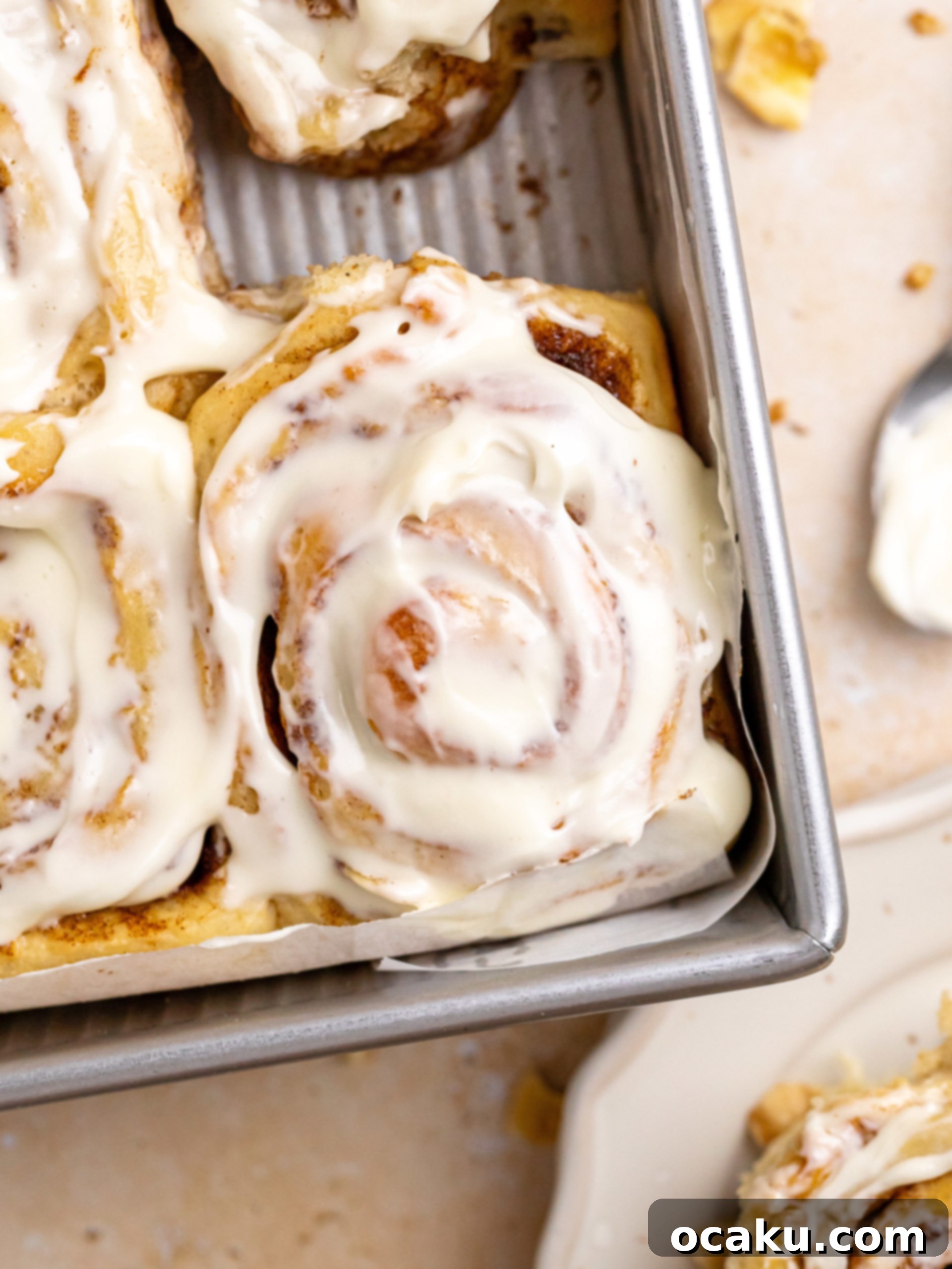 Close-up of baked banana cinnamon rolls in a pan, before frosting.