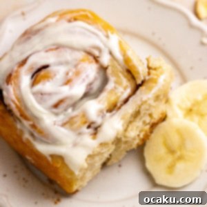 Close-up of a frosted banana cinnamon roll.
