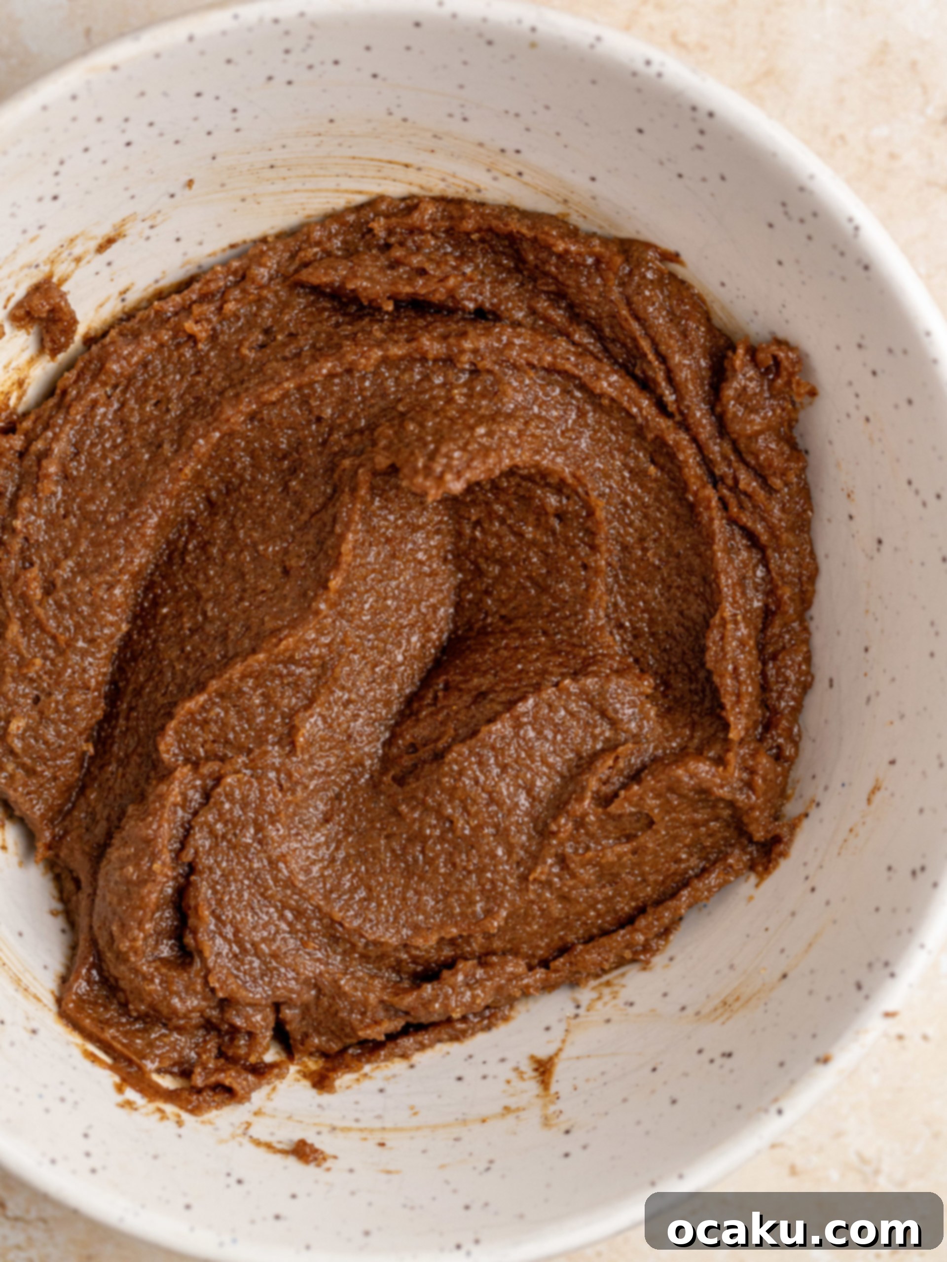 Image of butter being added to the dough.