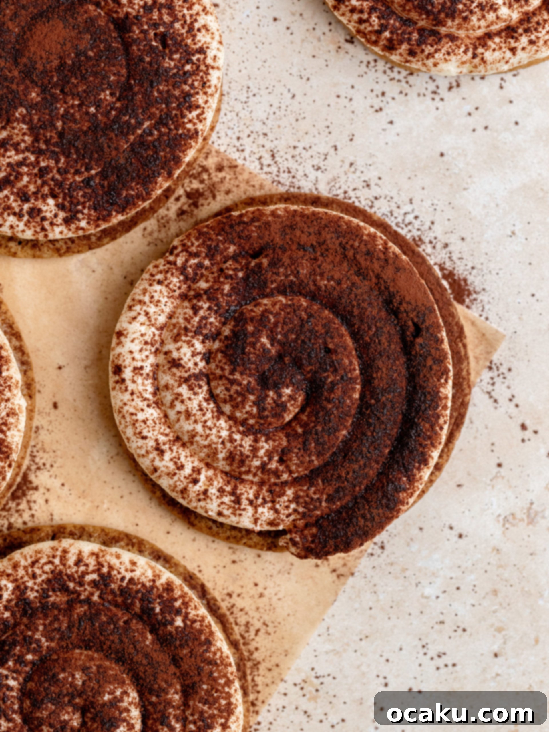 Coffee Mascarpone Cookies 12 A stack of three Tiramisu Cookies, prominently featuring their creamy tops and cocoa dusting.
