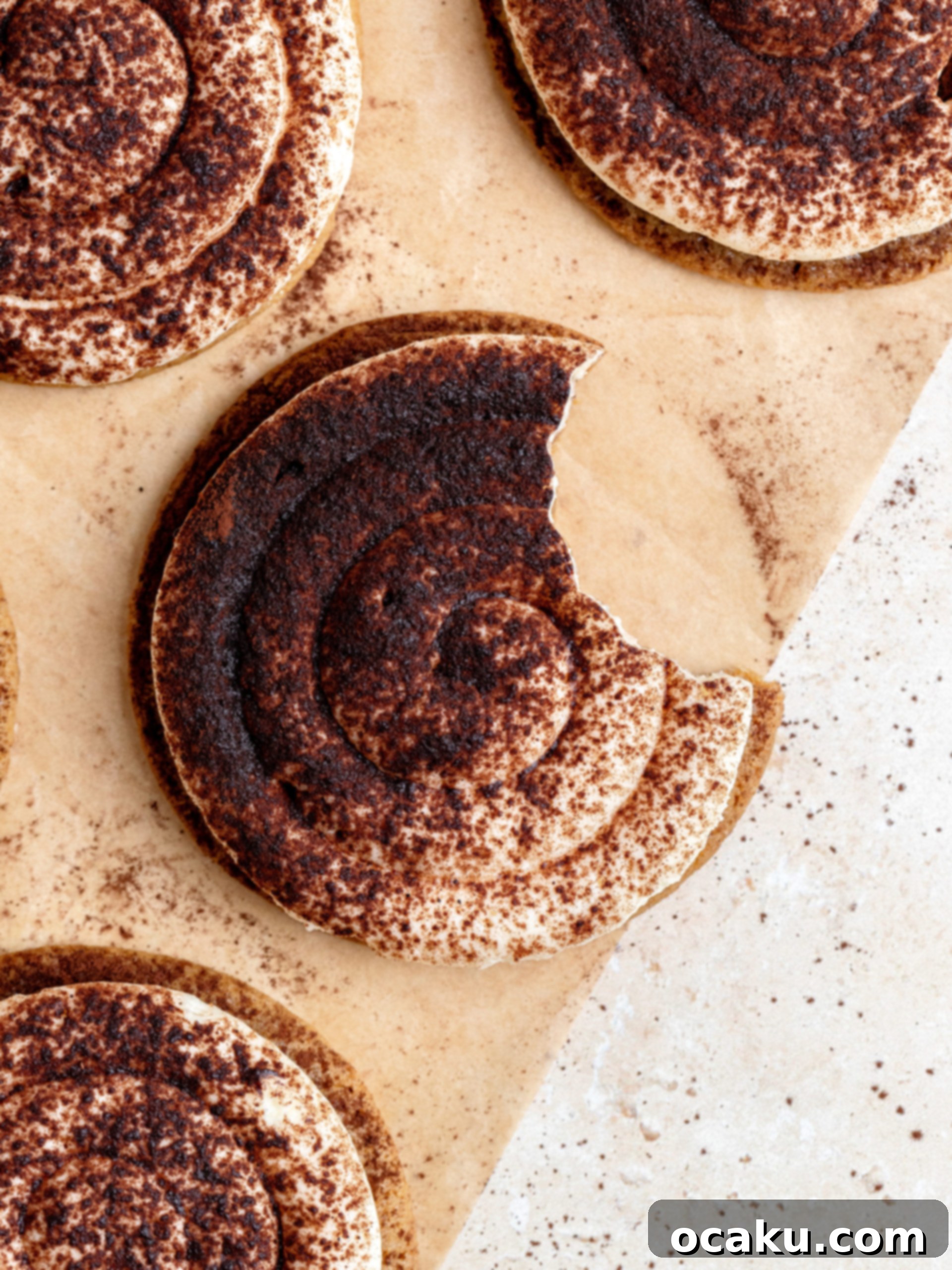Coffee Mascarpone Cookies 13 Artfully arranged Tiramisu Cookies on a plate, ready to be served, showing the light dusting of cocoa powder.