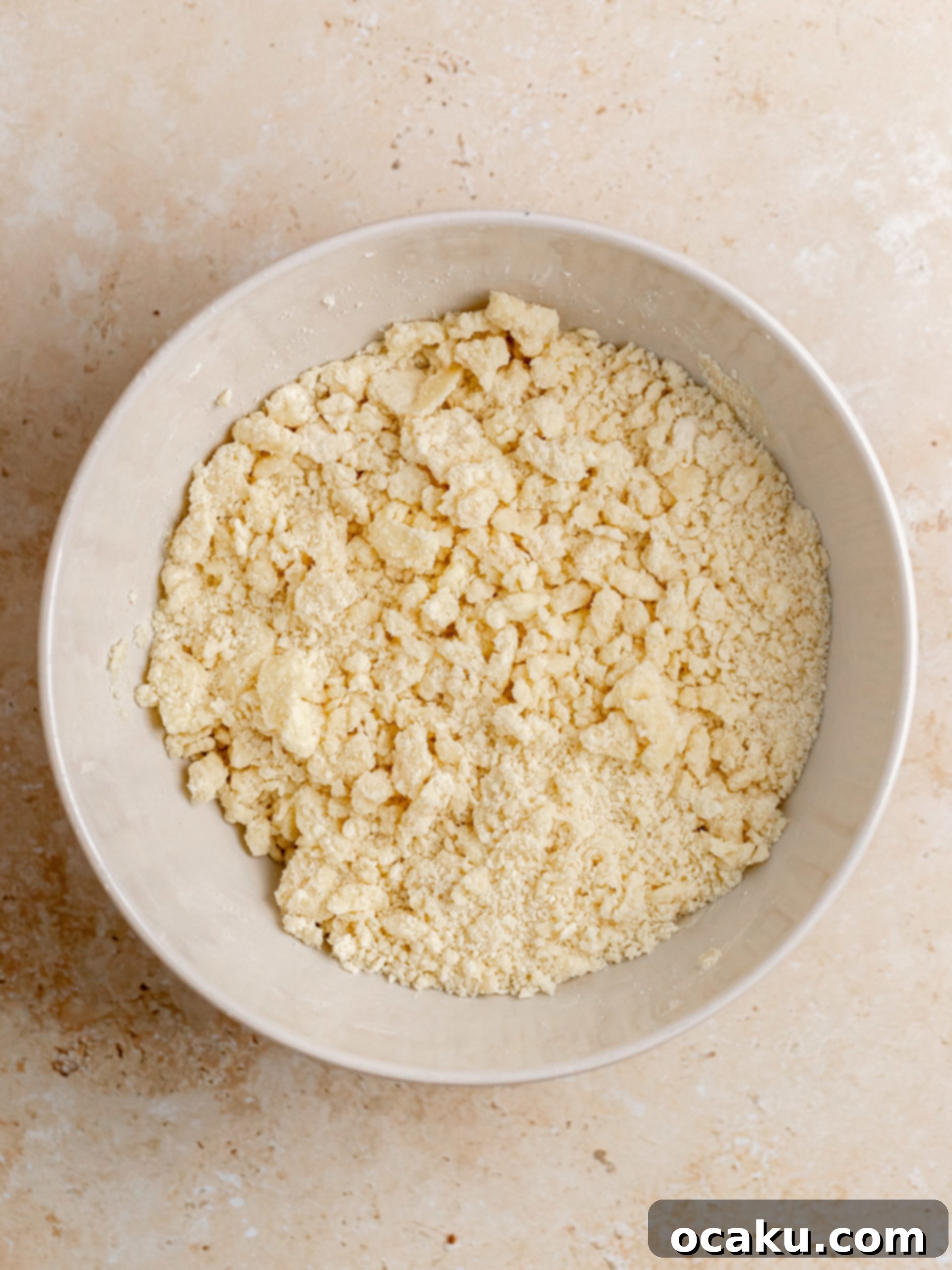 Twix Caramel Cheesecake 4 Step-by-step image showing flour, powdered sugar, and salt being mixed in a bowl for the shortbread crust.