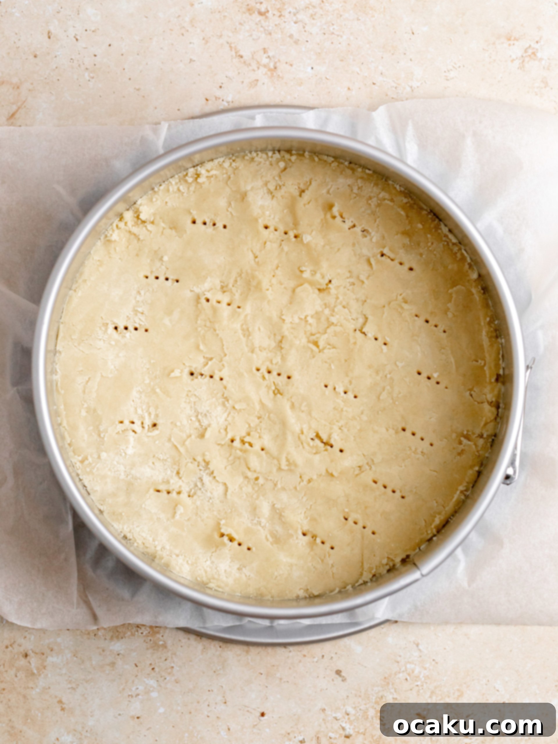 Twix Caramel Cheesecake 5 Step-by-step image showing butter being added to the dry ingredients and mixed until crumbly.