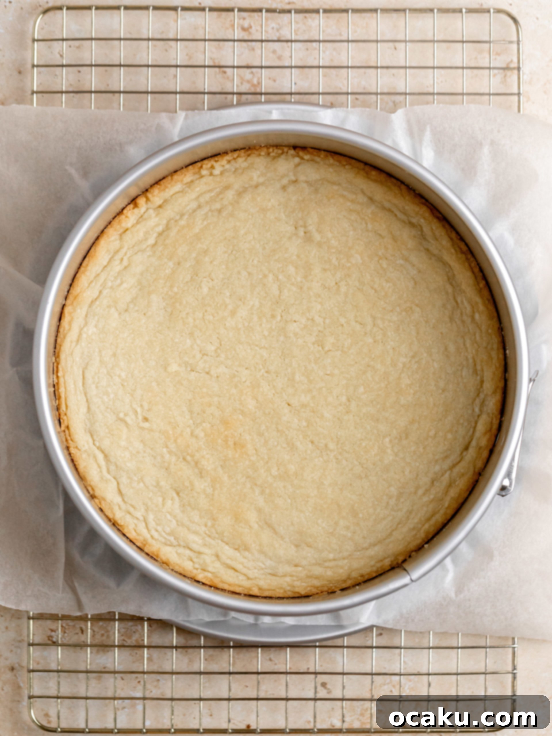 Twix Caramel Cheesecake 6 Step-by-step image showing cream cheese being creamed in a stand mixer.