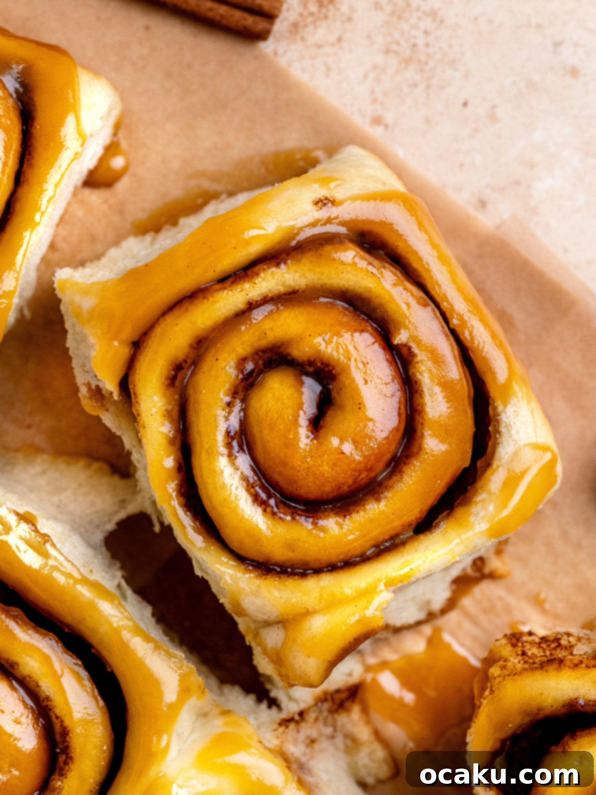 Close-up of golden brown caramel cinnamon rolls drizzled with rich caramel sauce.