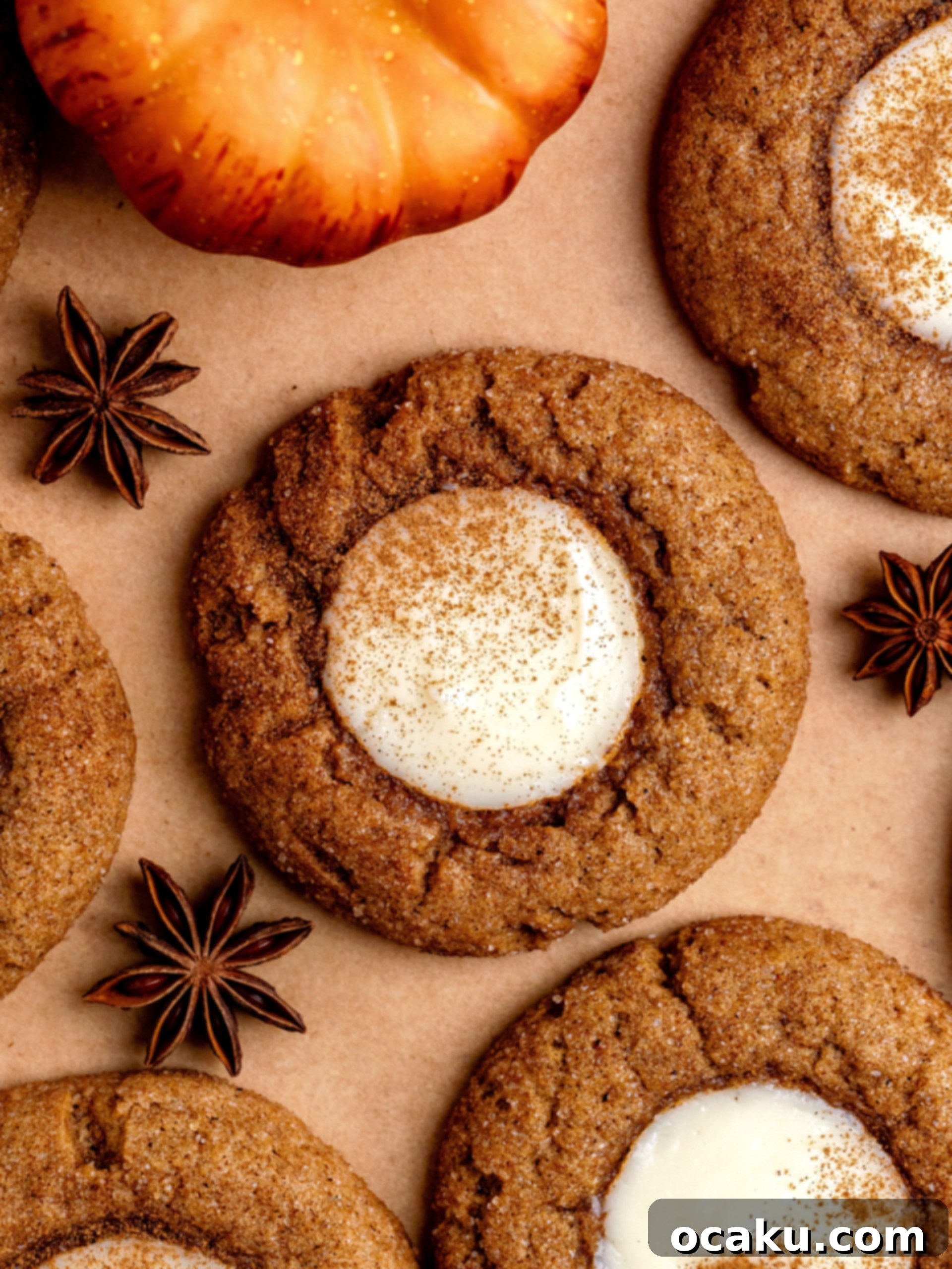 Close-up of a stack of pumpkin cheesecake cookies, showing the creamy filling and spiced sugar coating.