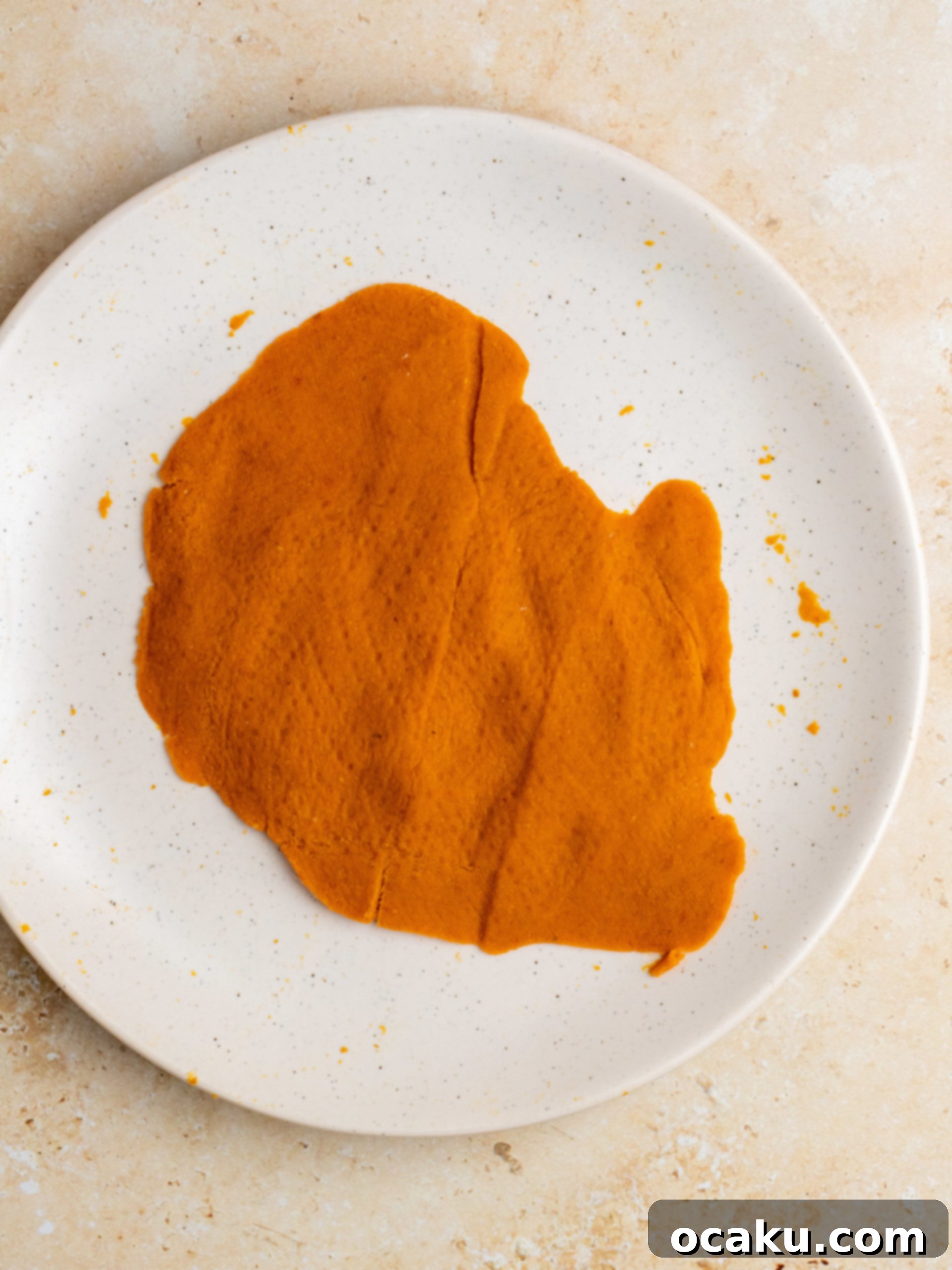 Combining sugars with cooled melted butter in a bowl.