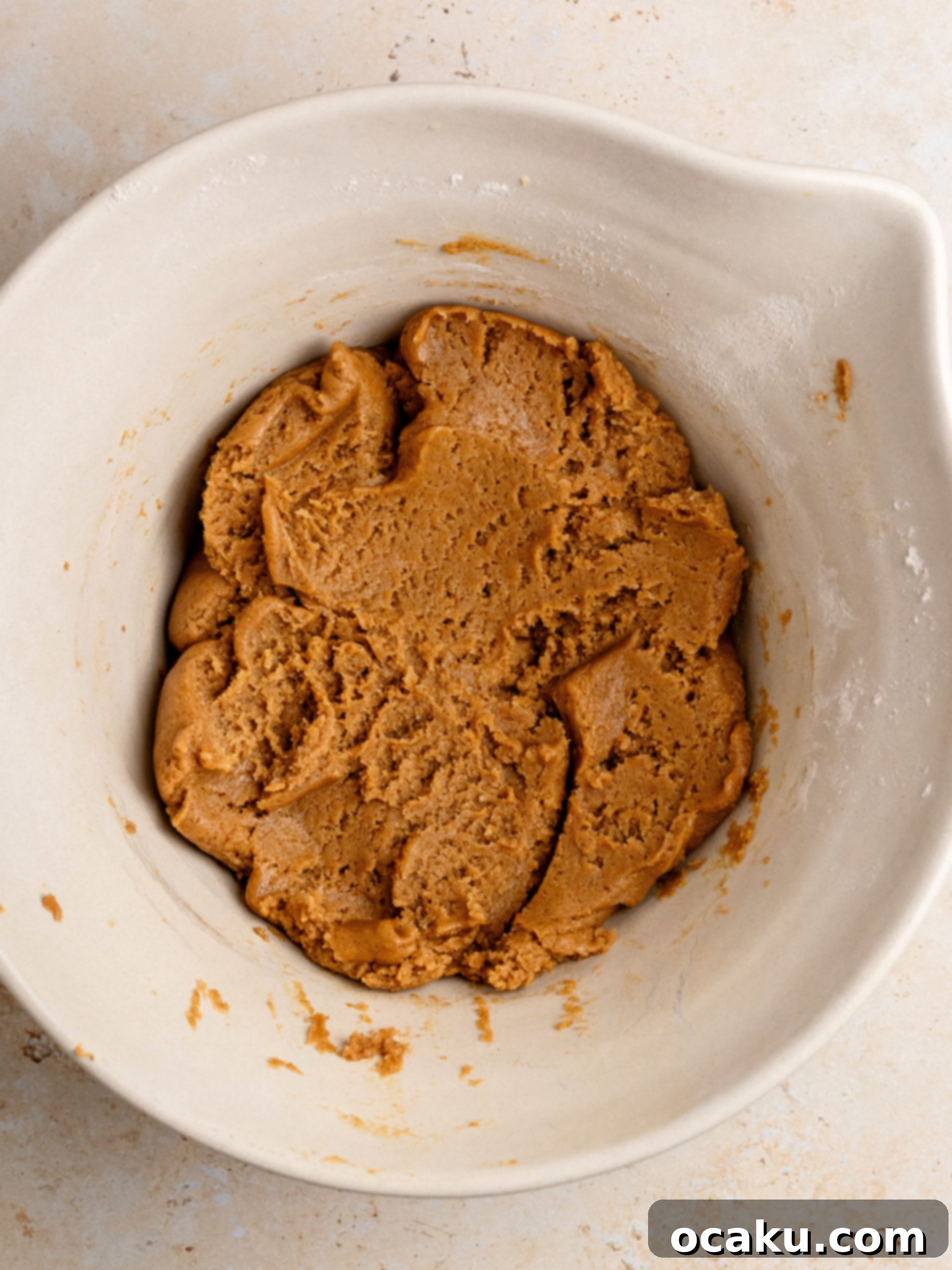 Mixing pumpkin puree and egg into the wet ingredients for cookie dough.