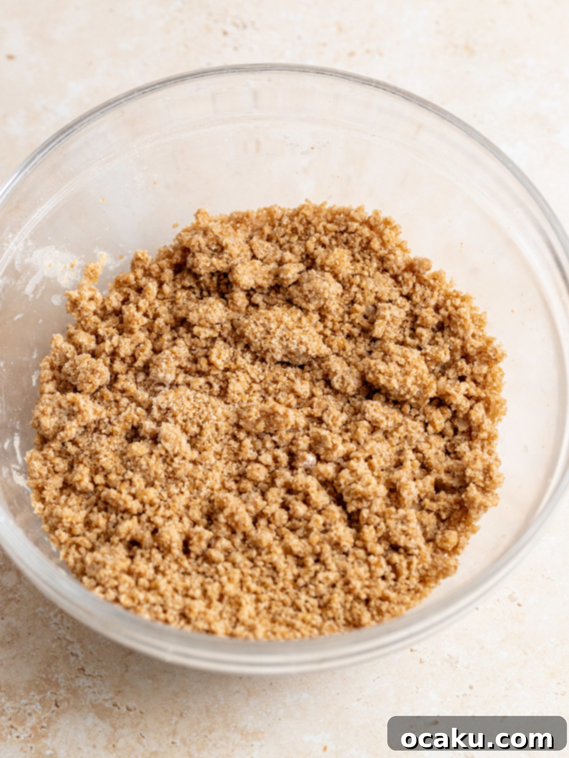 Spreading the first half of the vanilla cinnamon cake batter into the prepared springform pan.